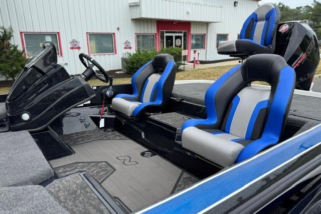 2026 Nitro Z21 XL boat interior with blue and gray seats, steering wheel, and console.
