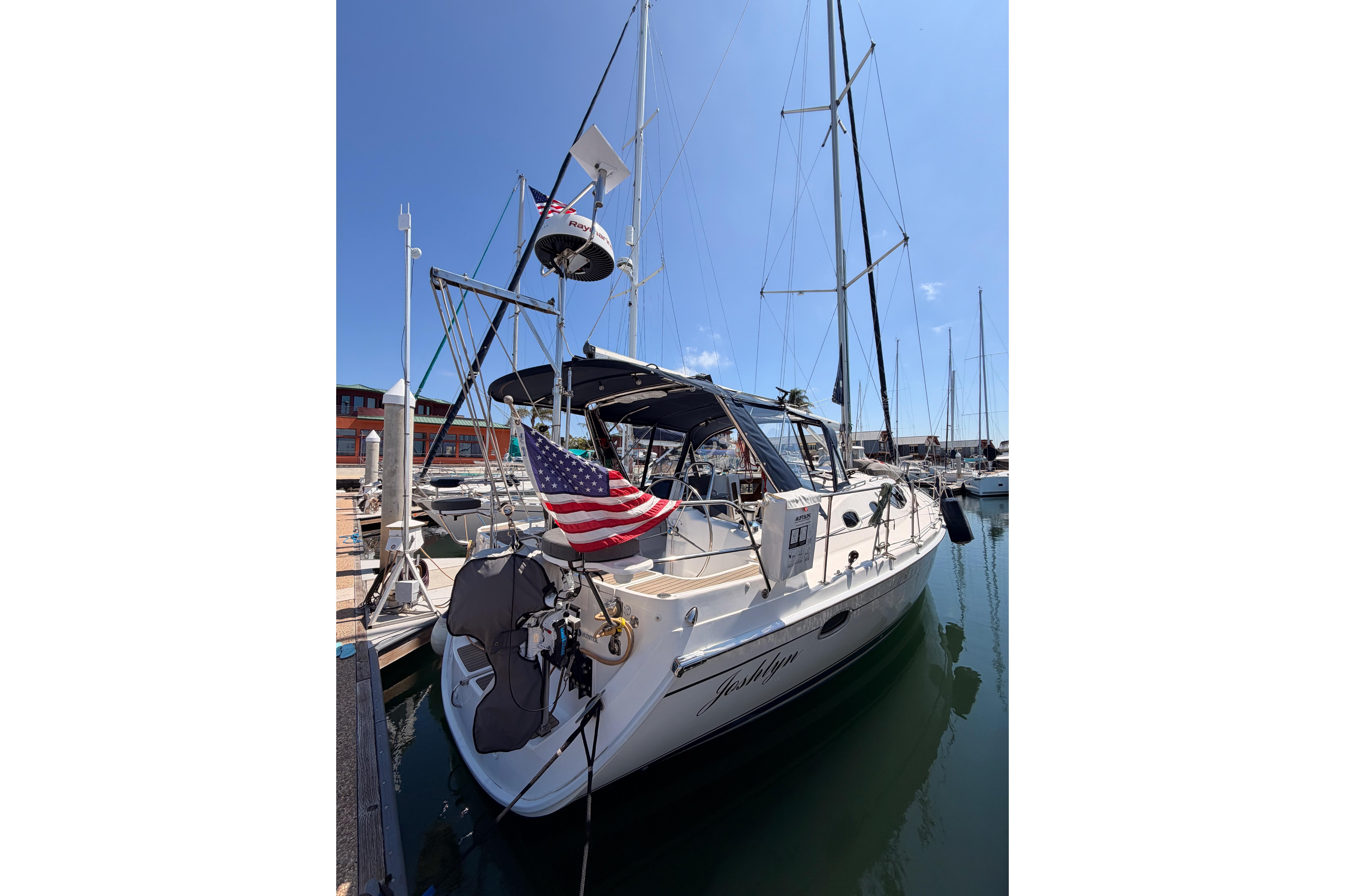 2008 Hunter 45 Deck Salon sailboat docked at marina with American flag.