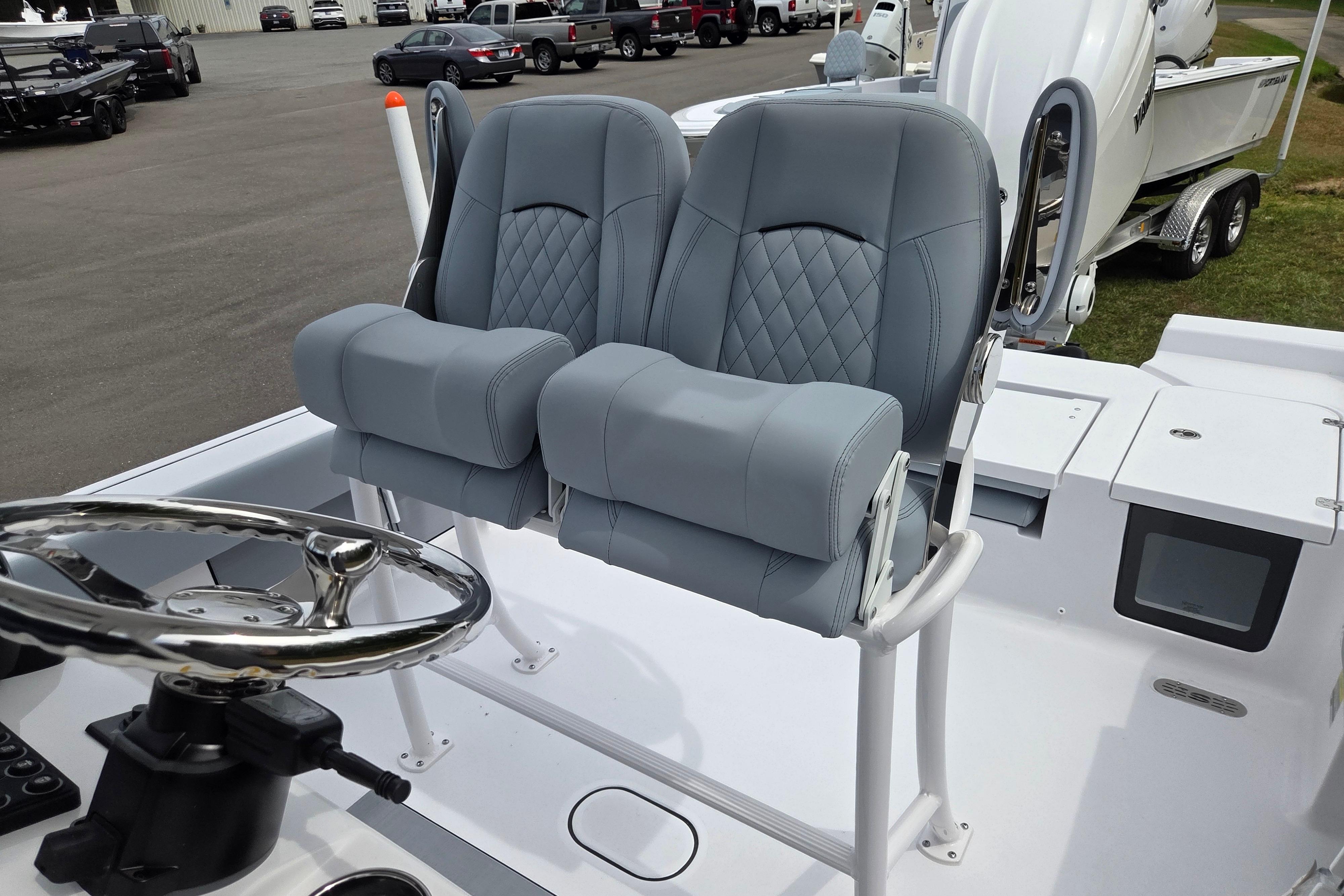 2026 Sportsman Masters 247OE Bay Boat with dual cushioned seats and steering wheel.