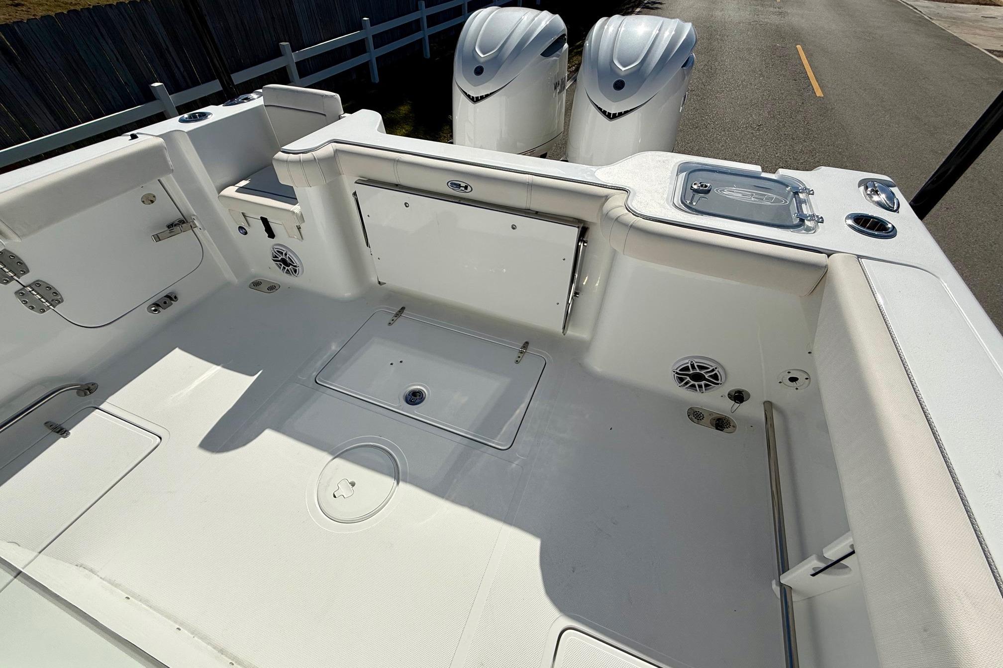 2026 Sea Hunt Gamefish 30 Coffin Box boat interior with dual engines and spacious deck.