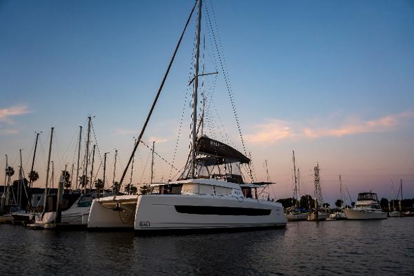 2021 Bali 4.8 catamaran docked at sunset in a serene marina setting.