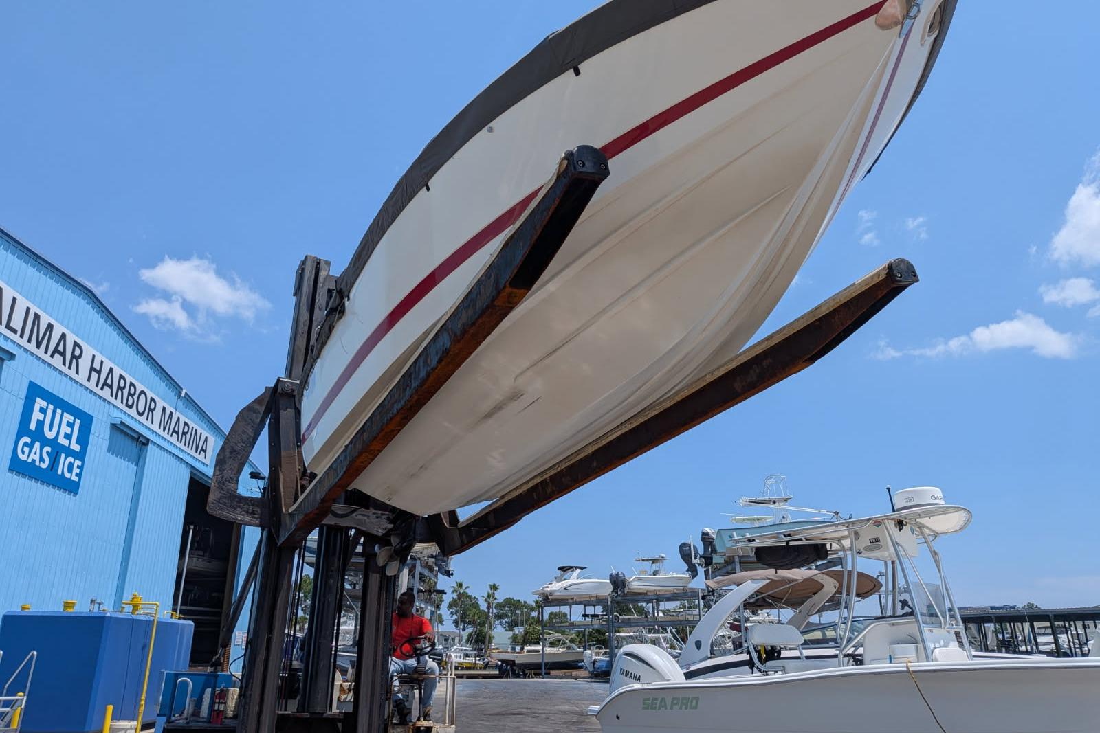 Boat being lifted at Valimar Harbor Marina, clear sky, Cobalt 206, 2020 model.