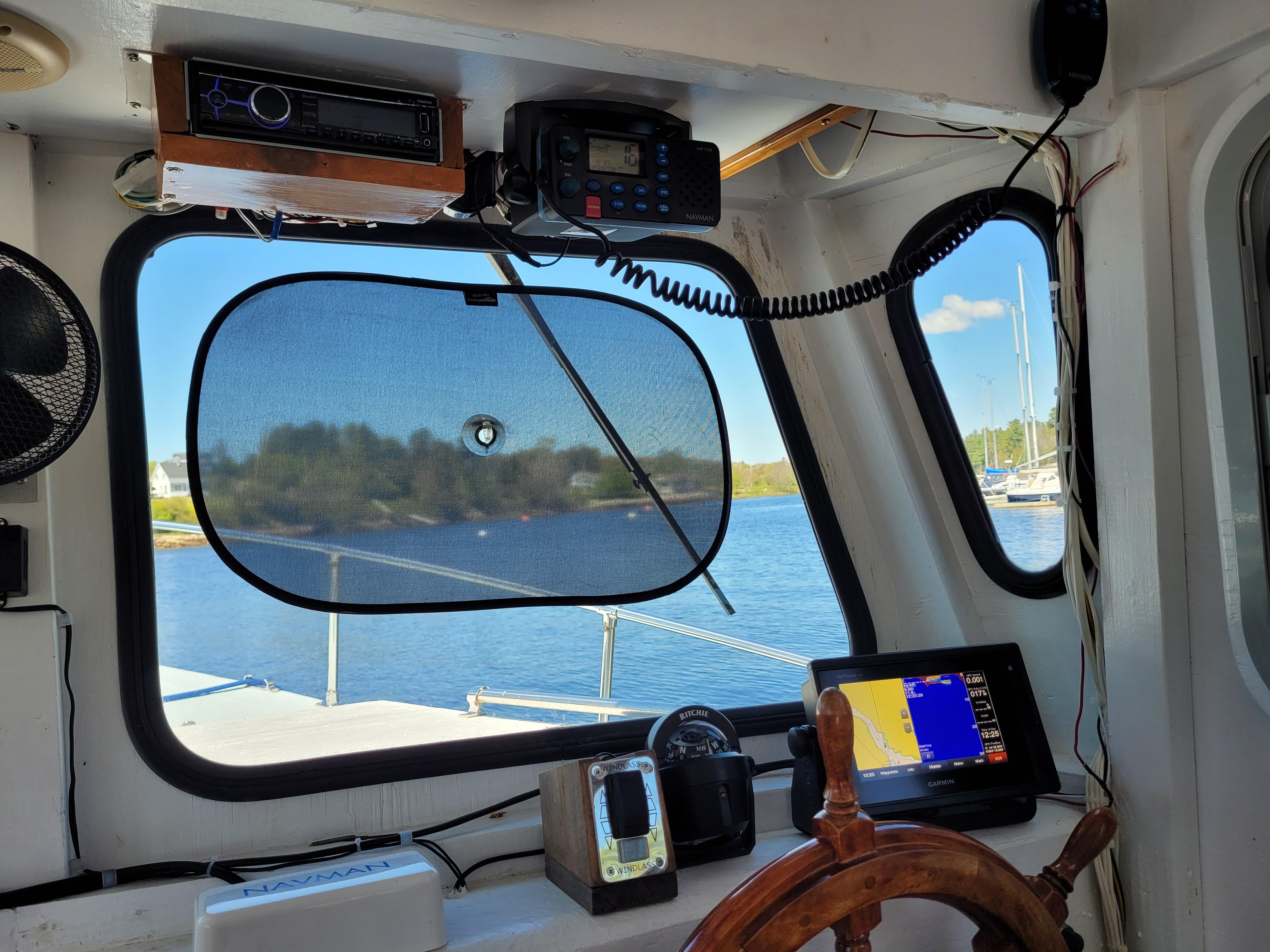 Pilothouse interior of 2009 Deschamp & Jackson Cape Island 32, featuring navigation equipment and scenic view.