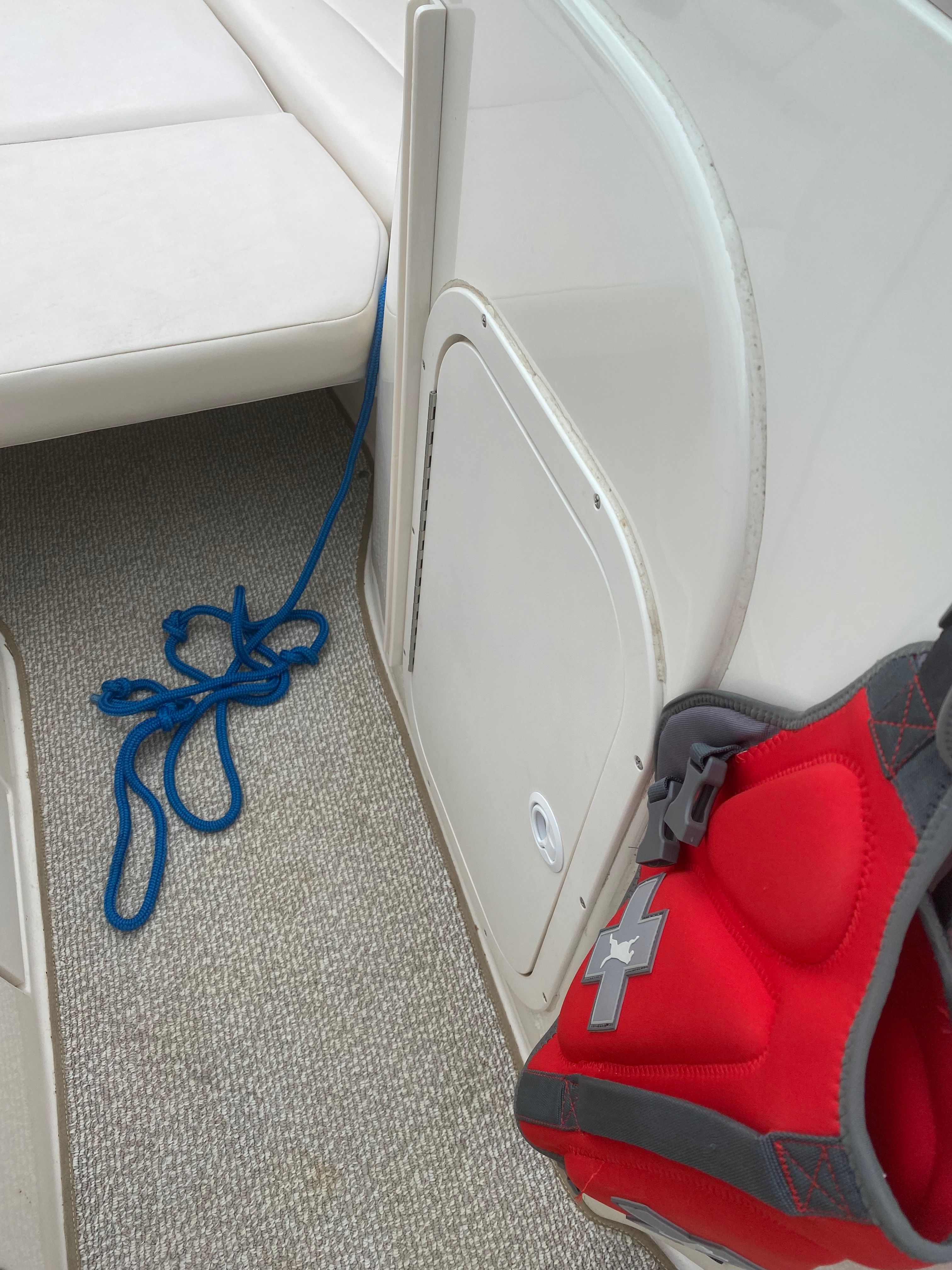 Interior of a Chaparral 230 SSi boat with red life jacket.