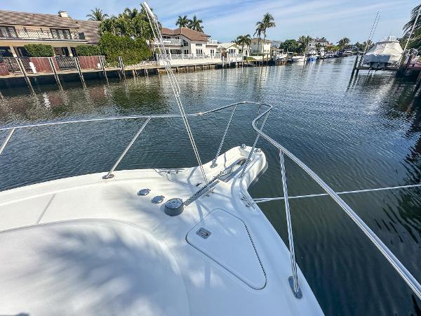 2006 Tiara Yachts 3200 Open on a serene canal with waterfront homes.
