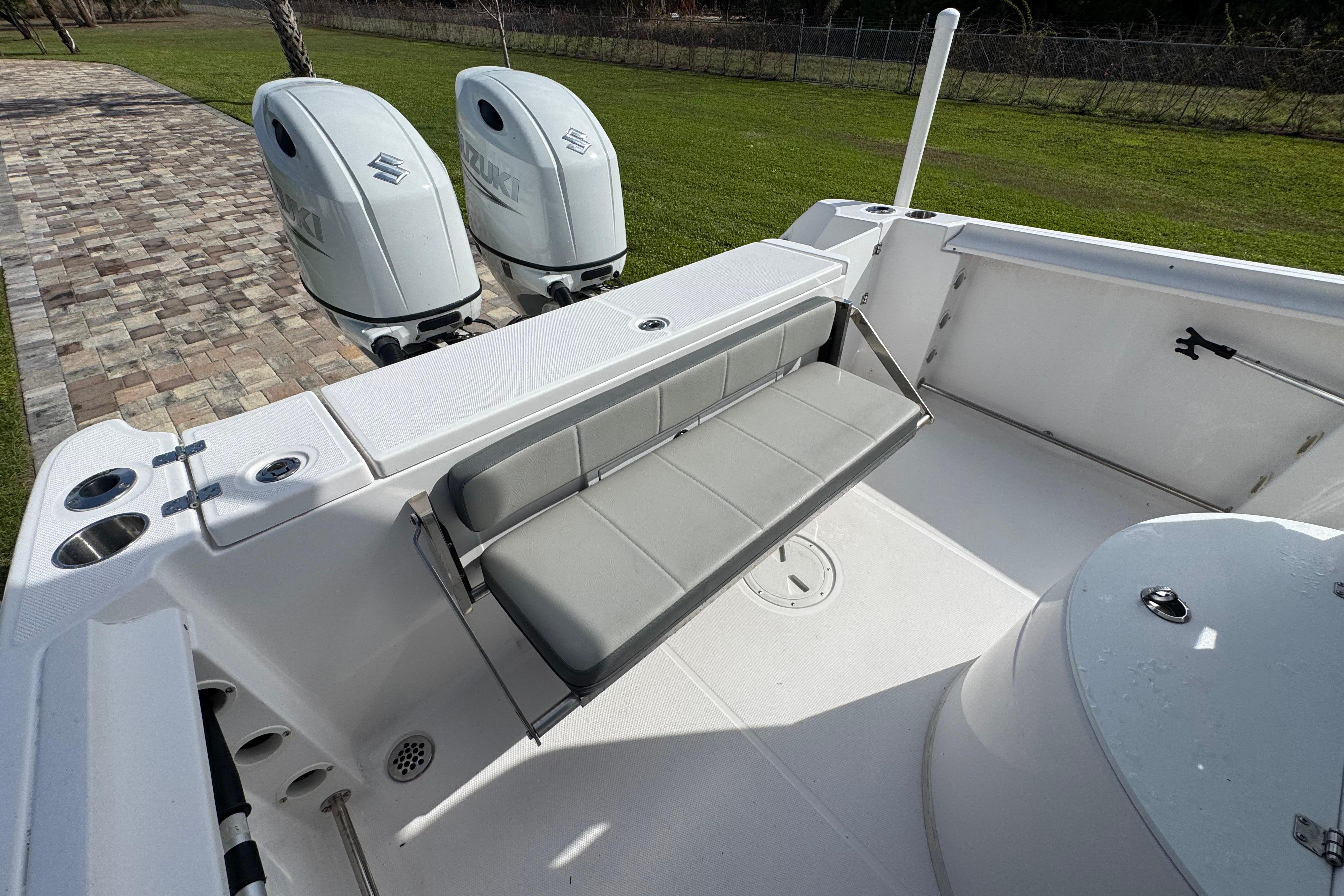 2022 Aquasport 2500 Center Console boat with dual Suzuki engines and seating area.