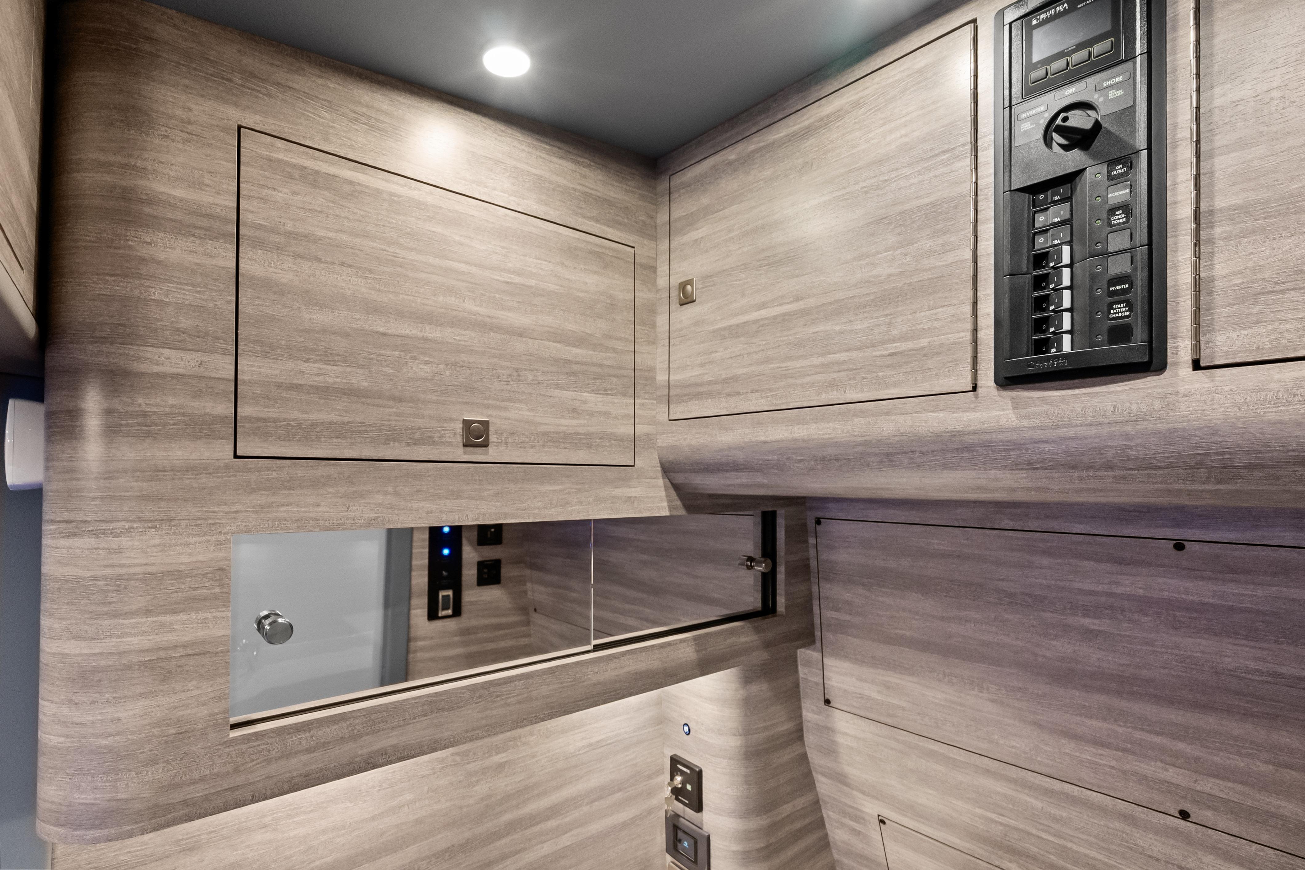 Interior of 2027 Mystic Powerboats M4200, featuring sleek wood paneling and control panel.