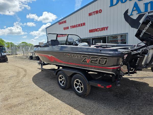 2025 Nitro ZV-20 SPORT boat on trailer, parked outside dealership under blue sky.