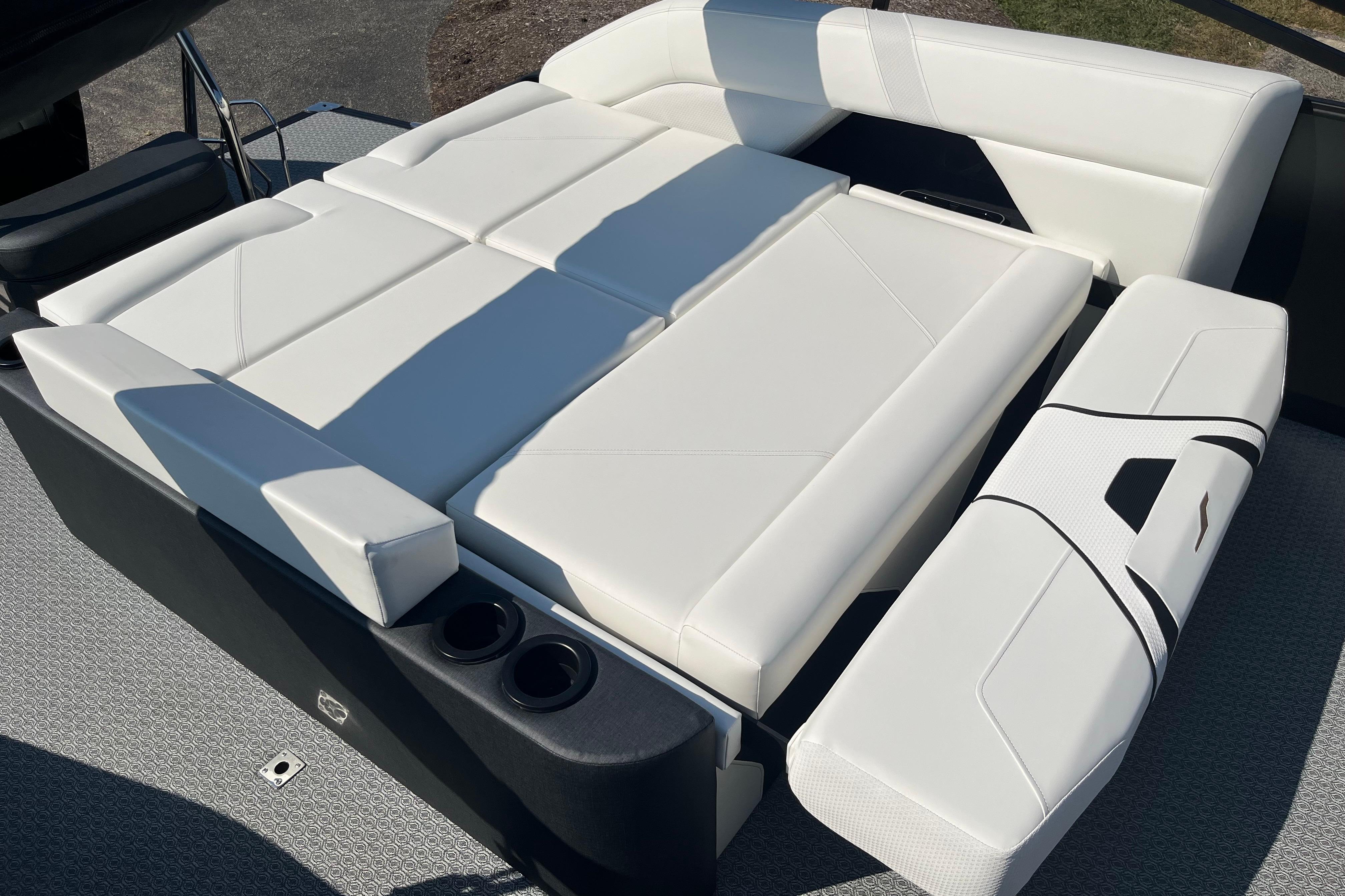 Luxurious white seating on 2026 Evotti 725CS boat, featuring cup holders and modern design.