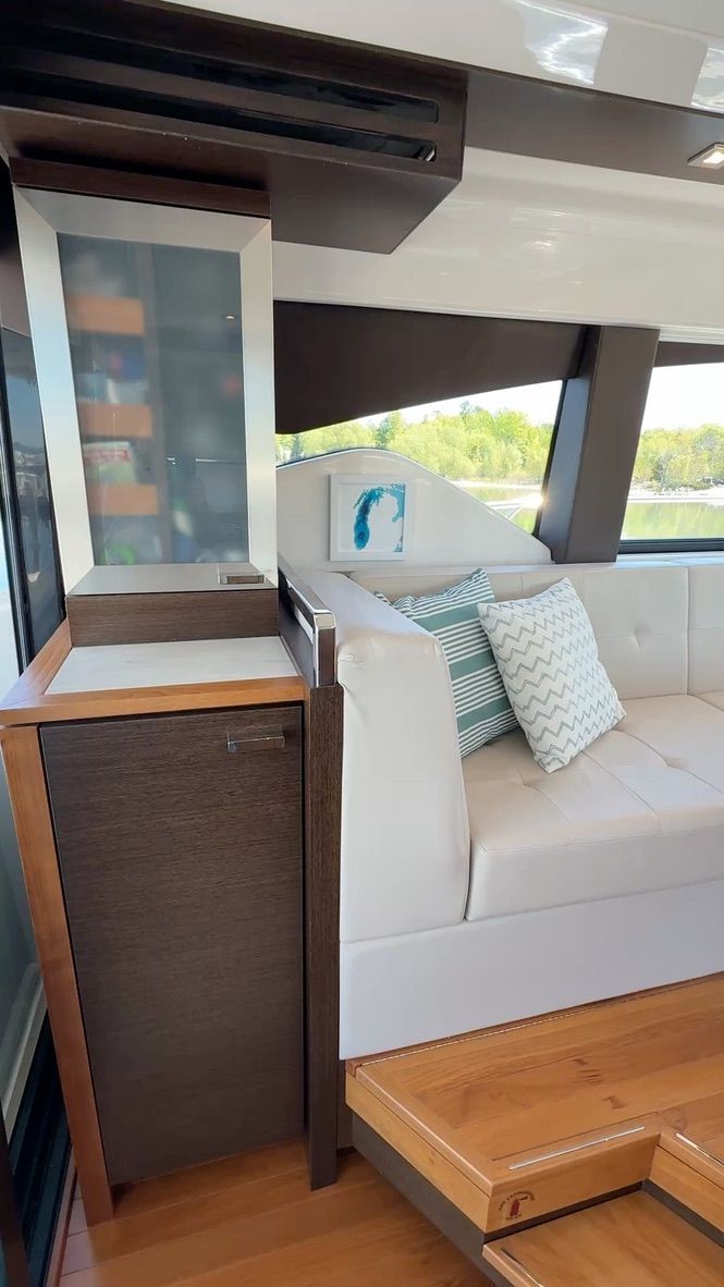 Interior of a 2017 Tiara Yachts C44 Coupe with white sofa and cushions.