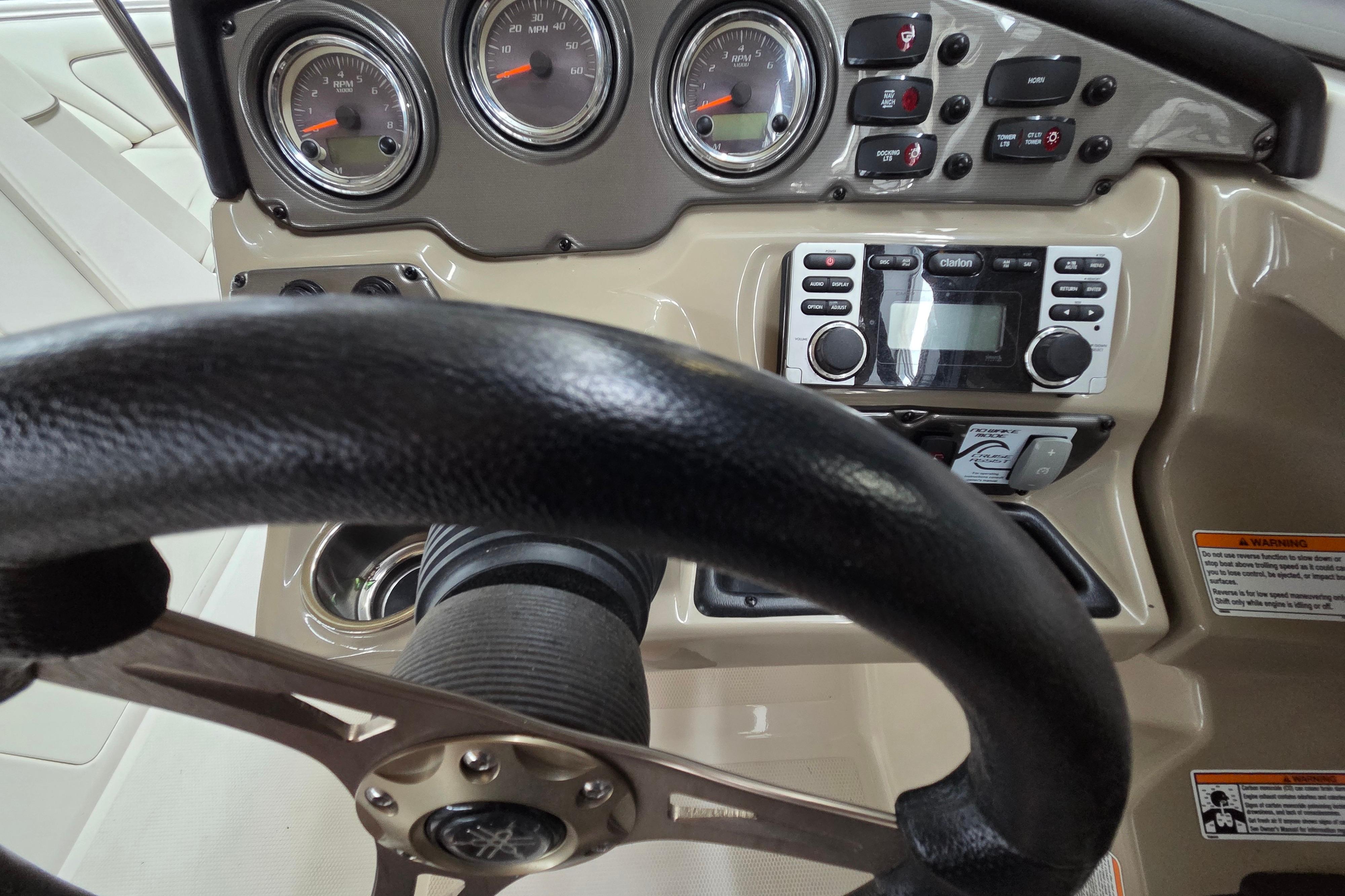 Dashboard of a 2013 Yamaha 242 Limited S boat with steering wheel and controls.