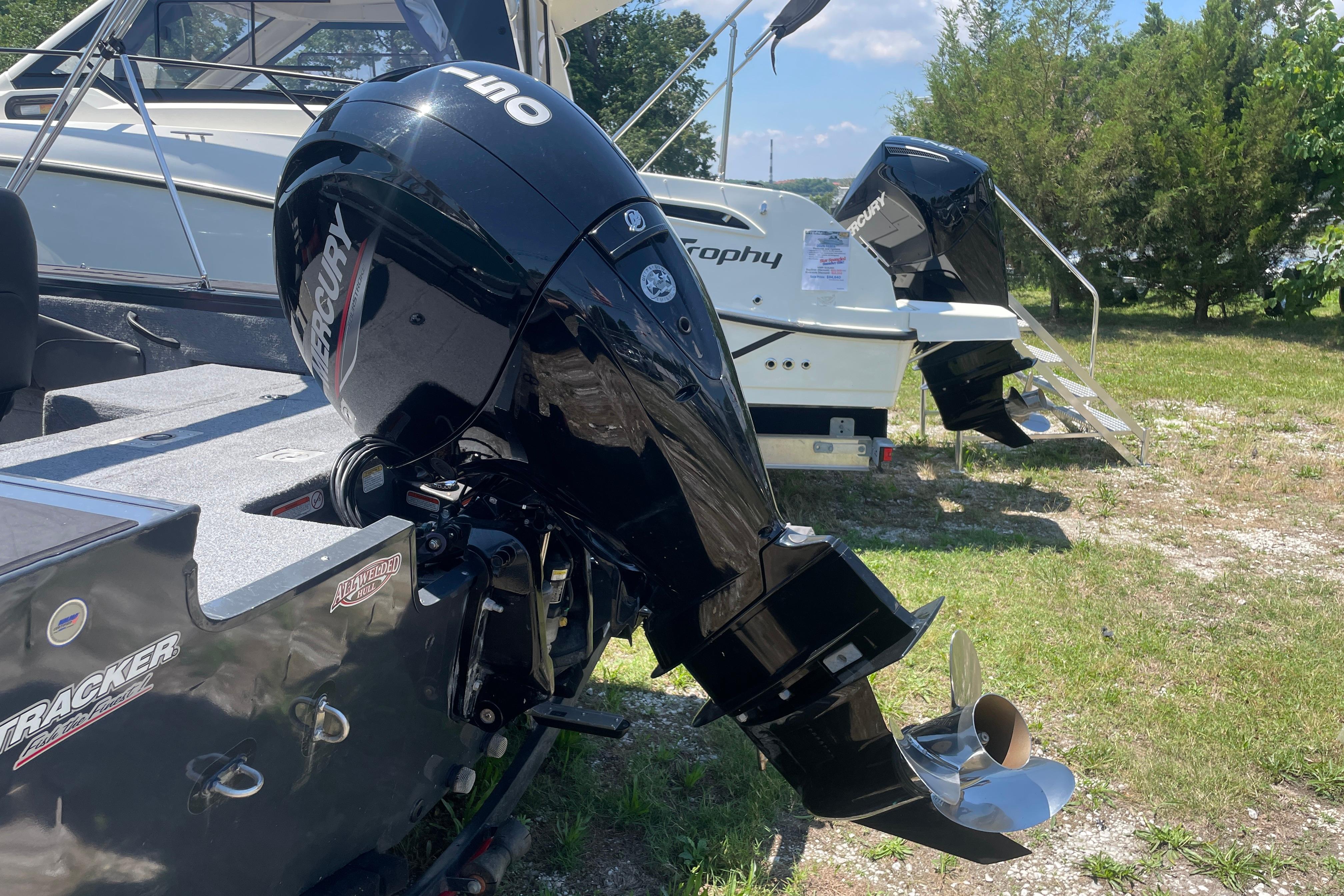 2022 Tracker Targa V-18 WT boat with Mercury outboard motor, parked outdoors.