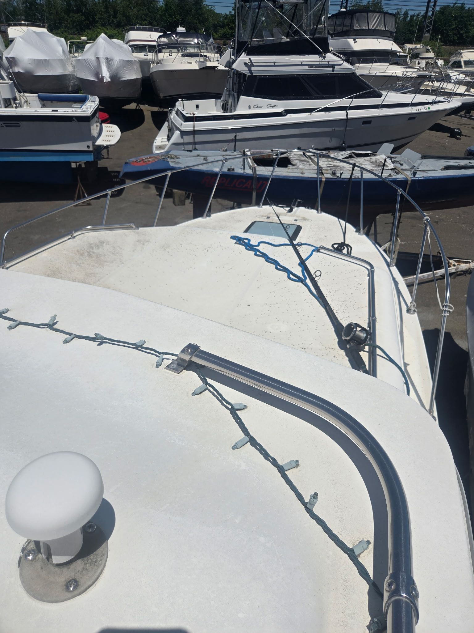 2003 Bayliner 28 boat docked among other boats.