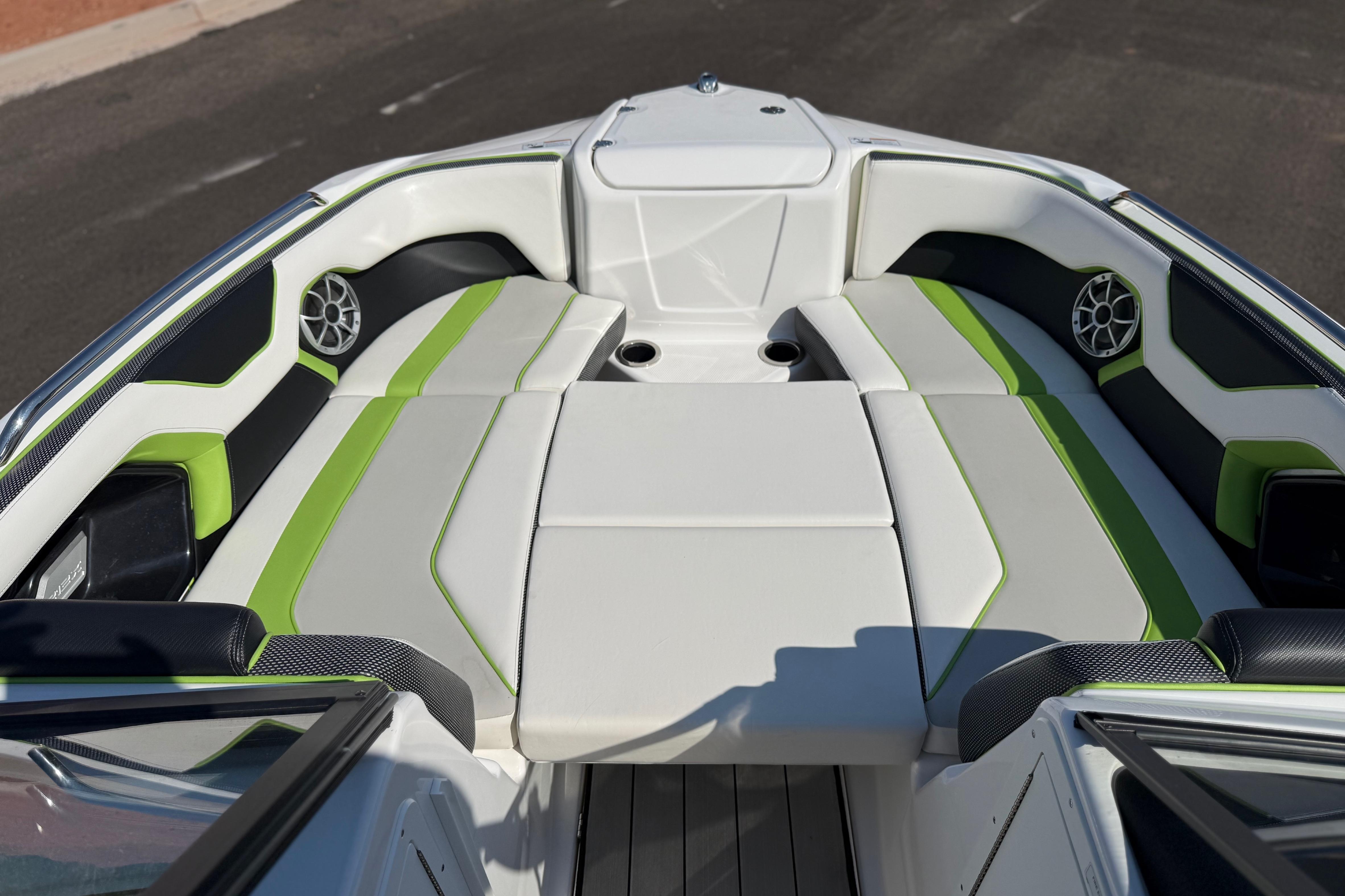 2022 Yamaha Boats 212XE interior with green-accented seating and built-in speakers.