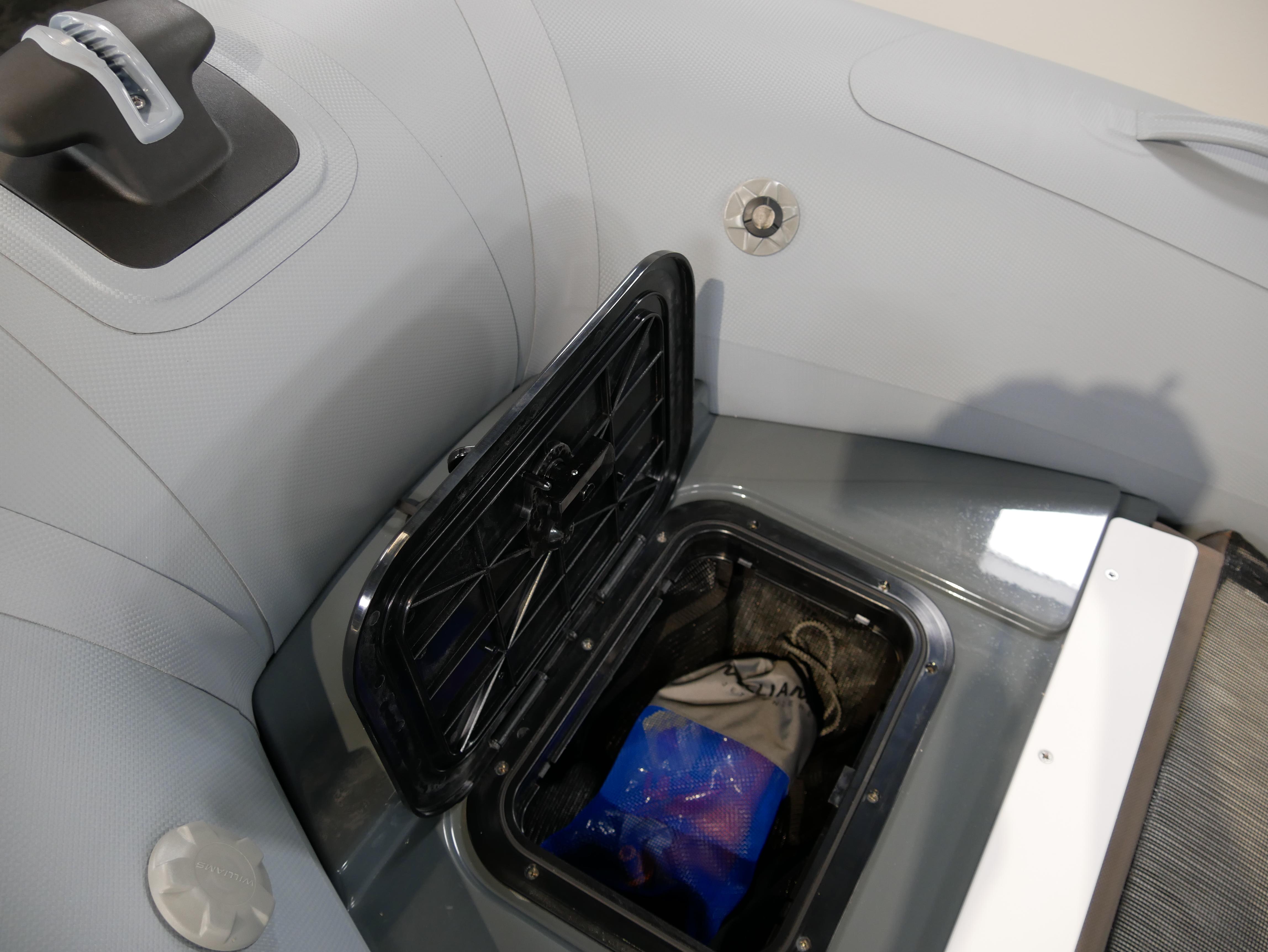 2025 Williams Jet Tenders SportJet 435 storage compartment with open hatch, showcasing interior space.