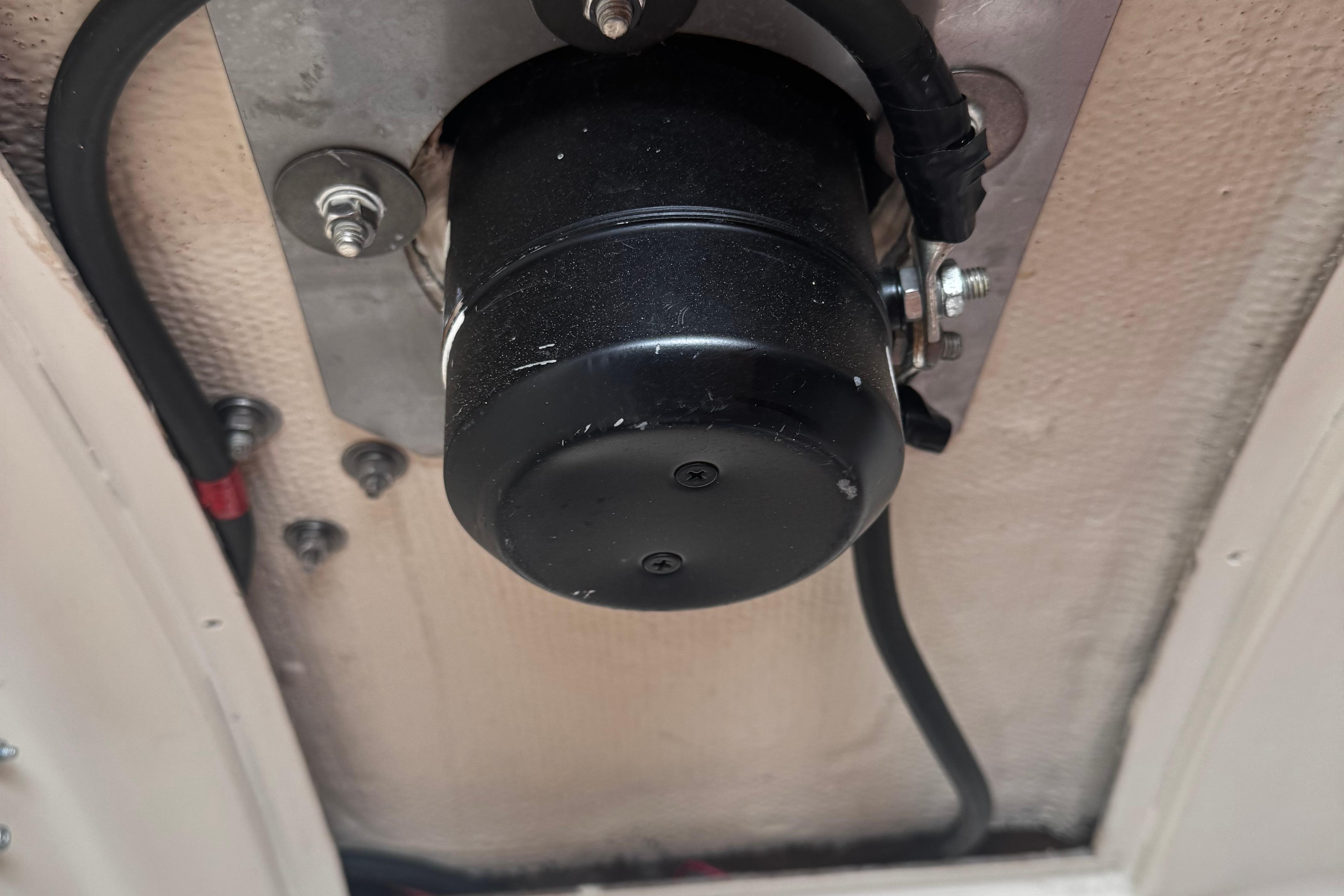 1984 Nonsuch 26 Classic boat component, black cylindrical part with wiring and bolts.