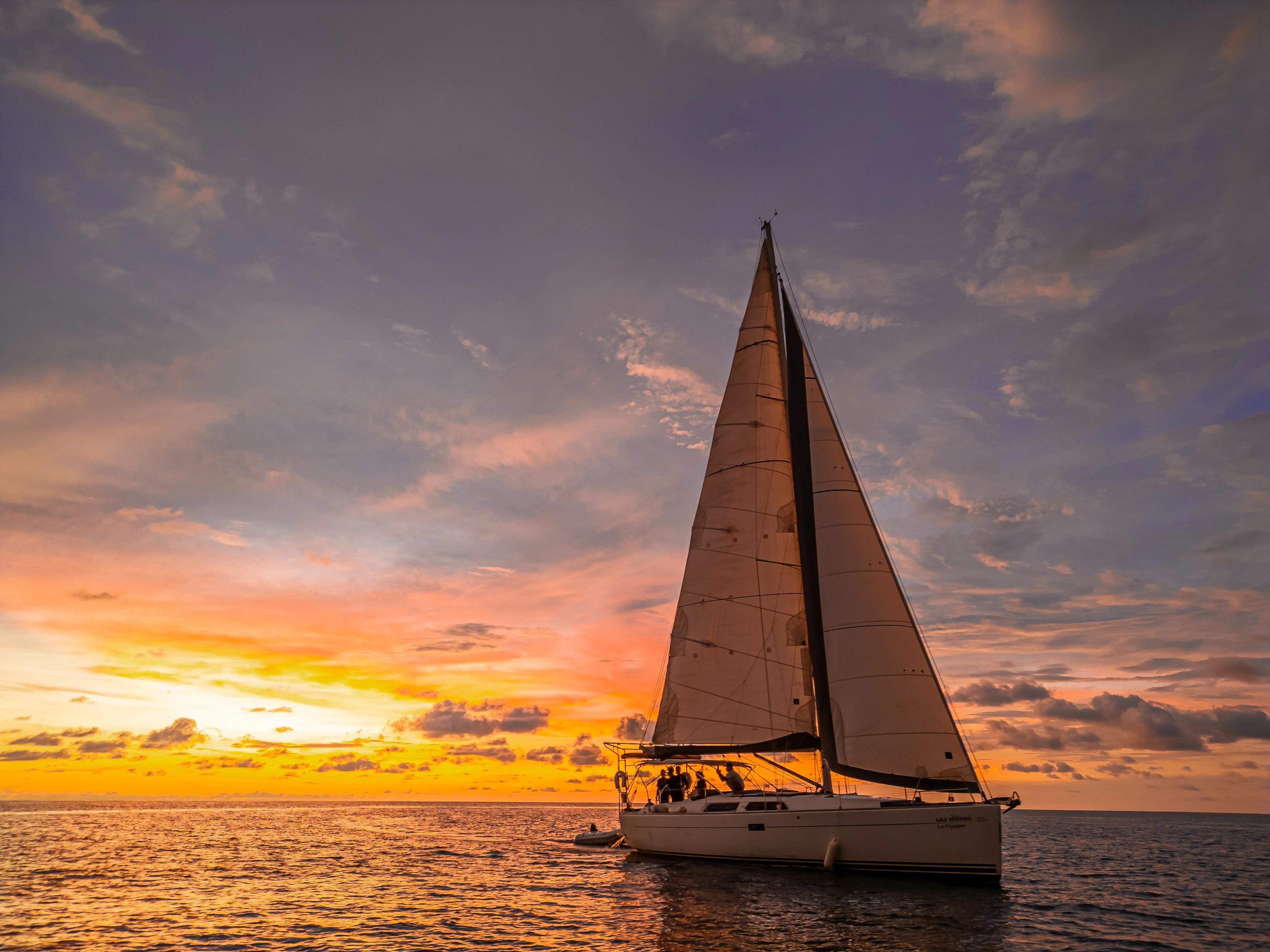 Sailing yacht Hanse 400, 2011 model, at sunset on calm ocean waters.