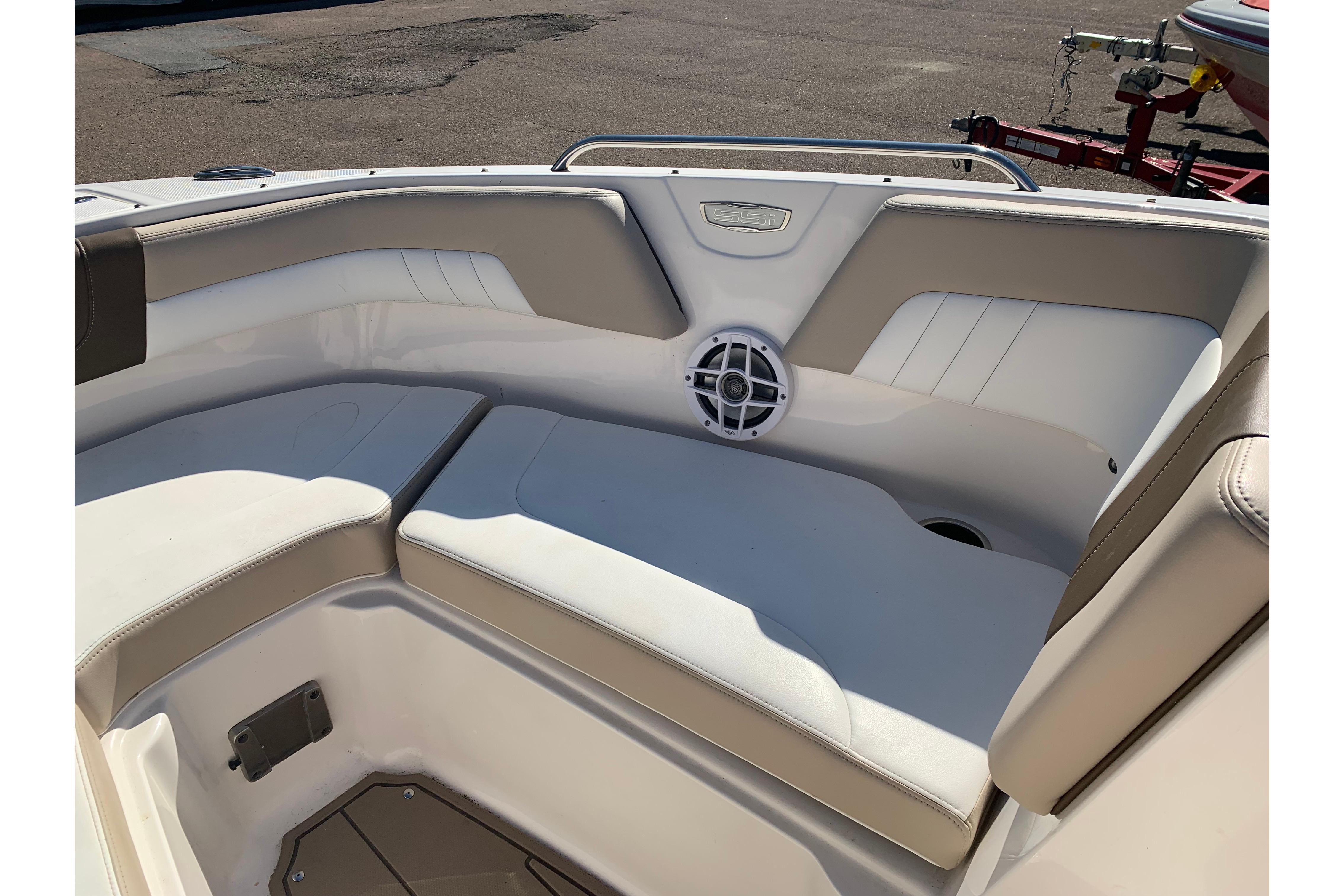 Interior seating of 2022 Chaparral 23 SSi boat with beige and white upholstery.