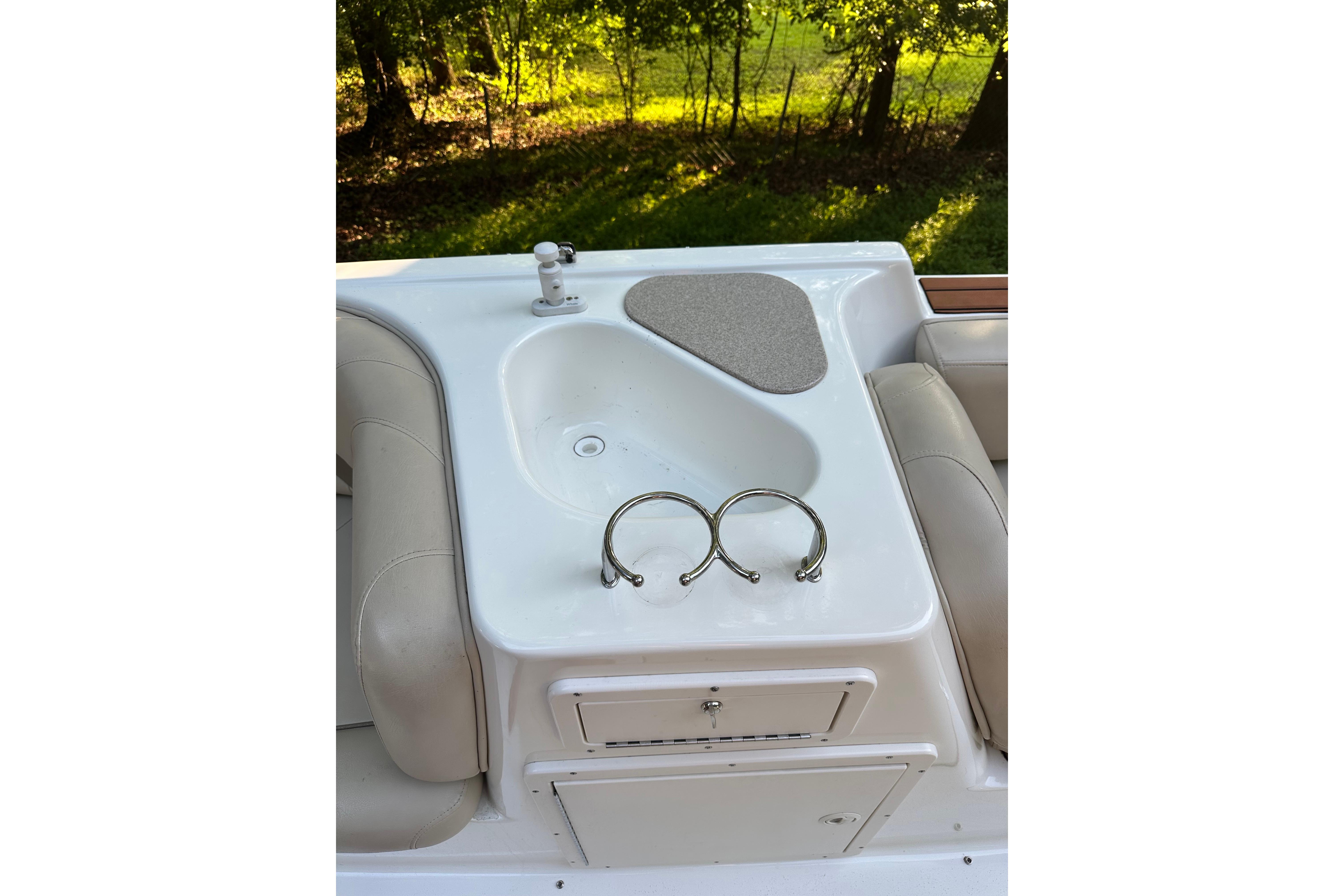 2008 NauticStar 230 SL Sport Deck I/O boat sink and seating area.