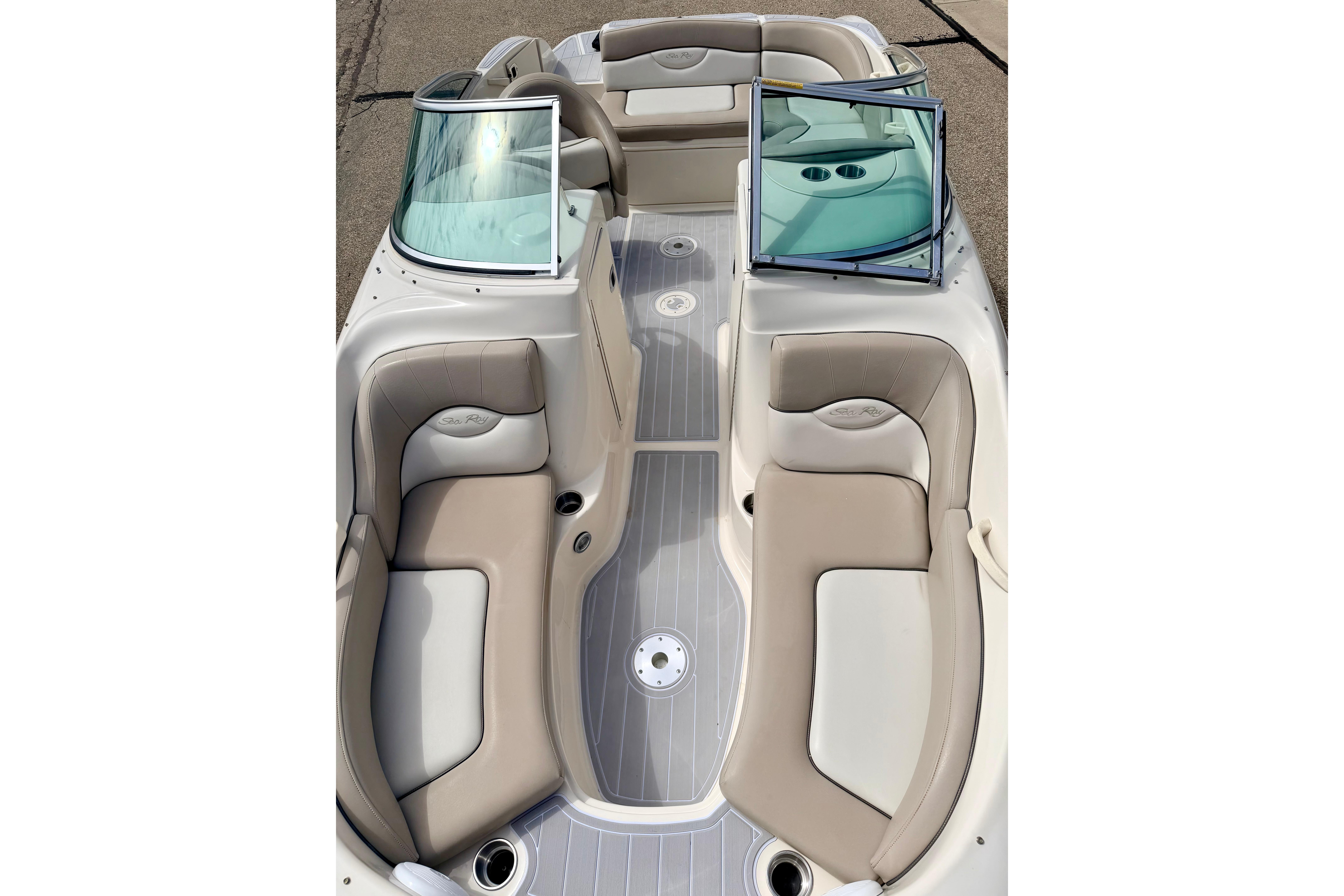 2003 Sea Ray 200 Sundeck boat interior with beige seating and windshield.