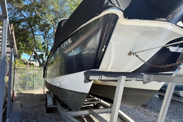 2003 World Cat 270 EC boat on trailer, parked outdoors.