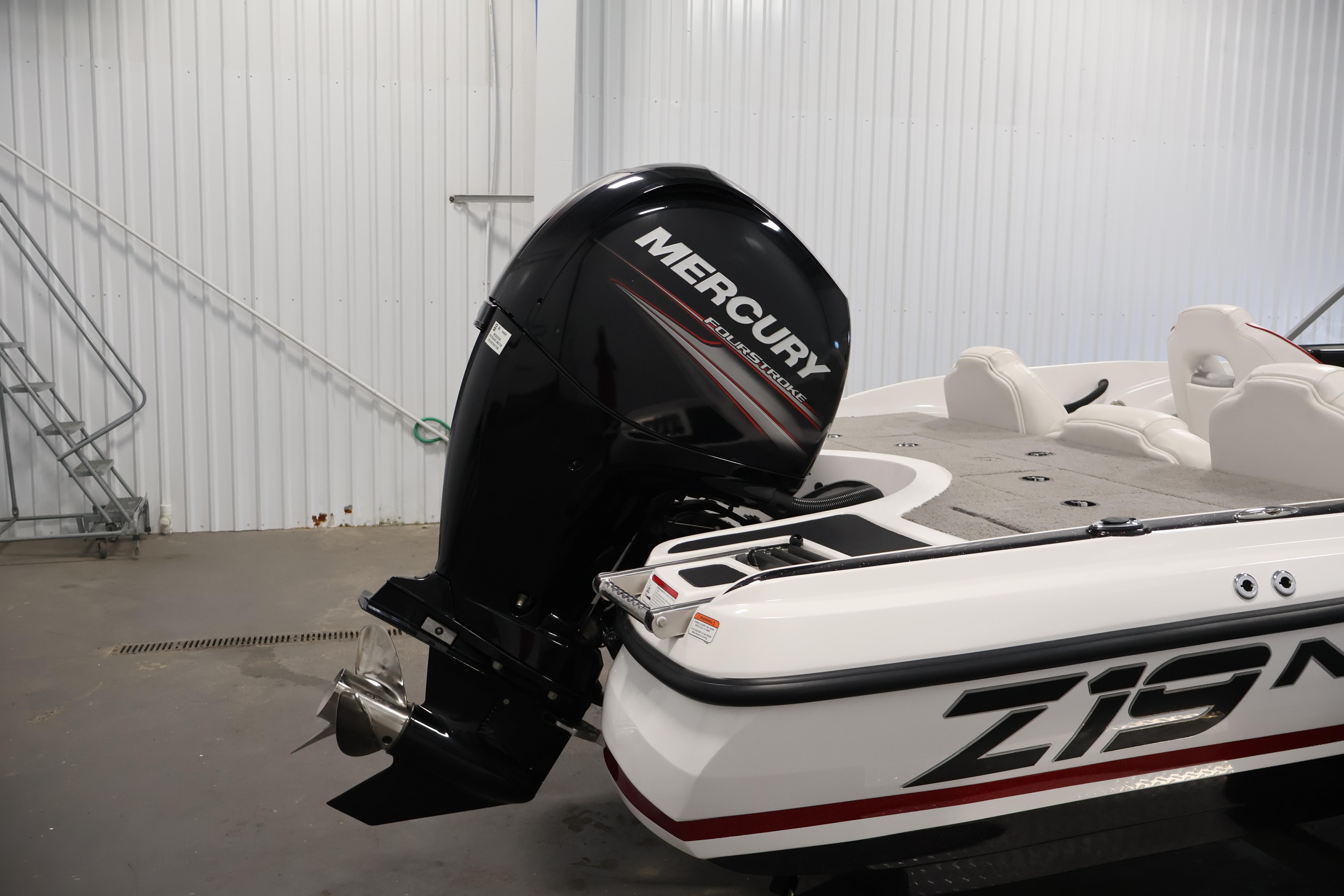2019 Nitro Z19 Sport boat with Mercury outboard motor in a garage setting.