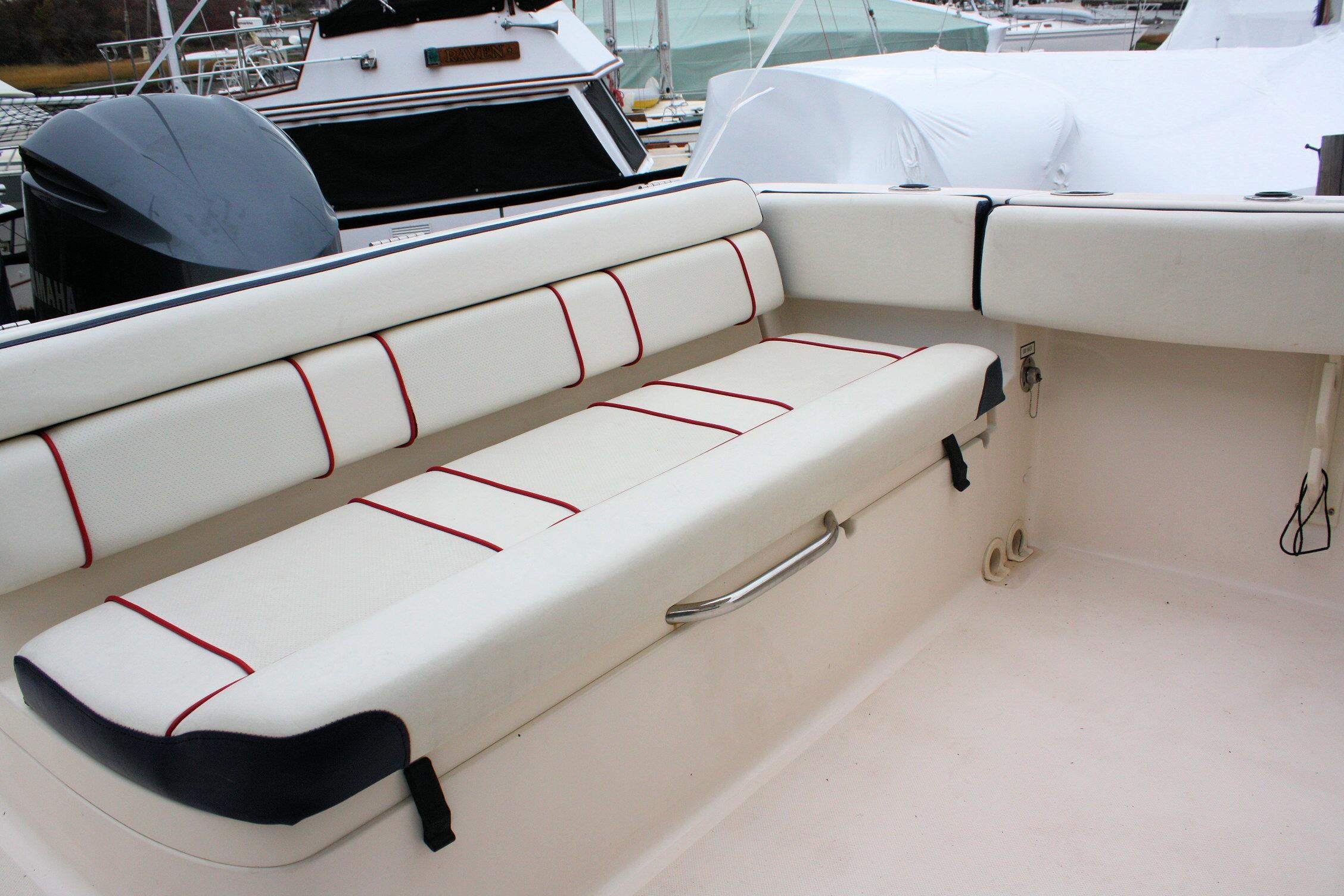 2013 Pursuit ST 310 Sport boat interior with white seating and red accents.