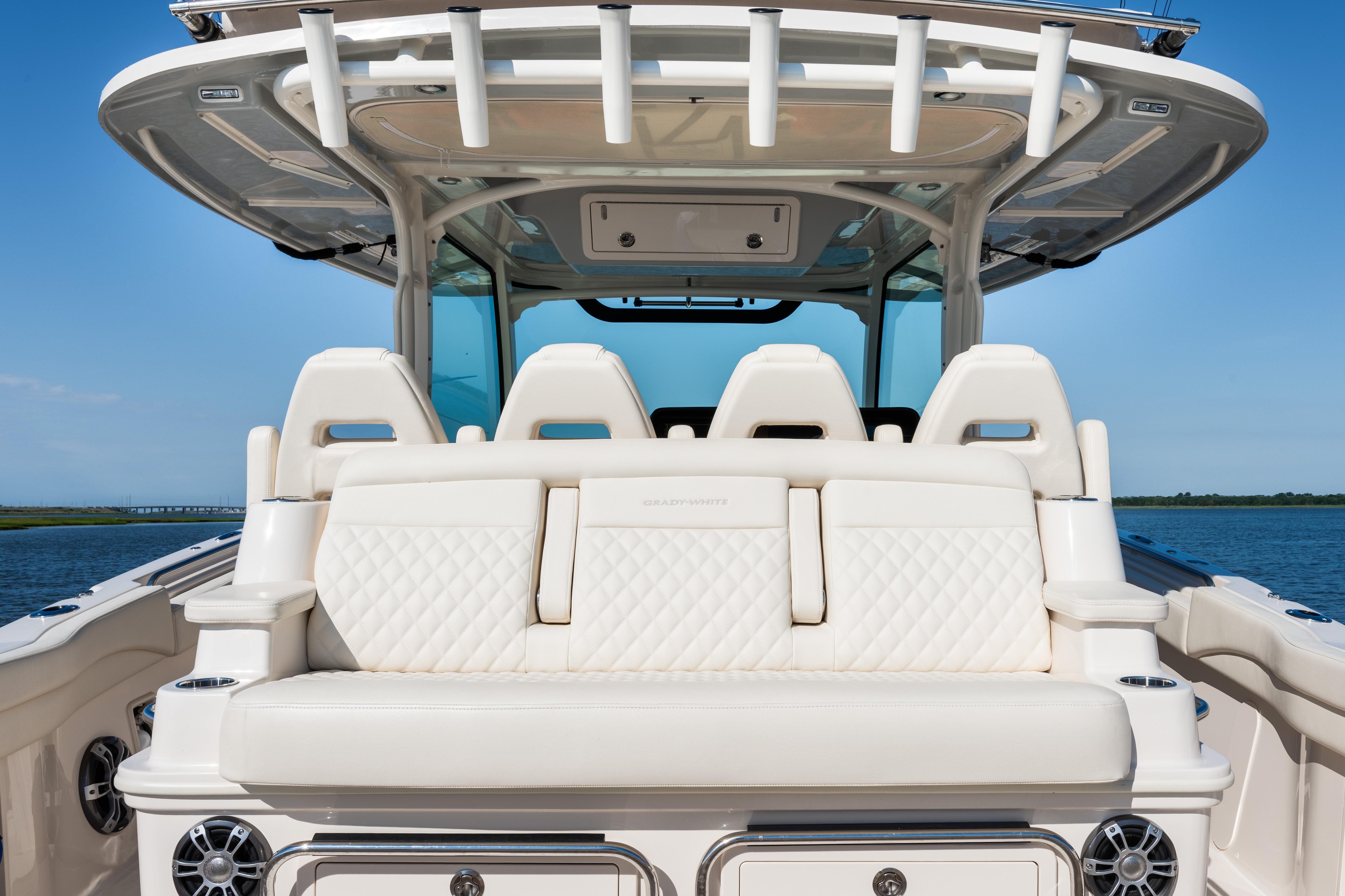 2025 Grady-White Canyon 386 boat interior with luxurious seating and ocean backdrop.