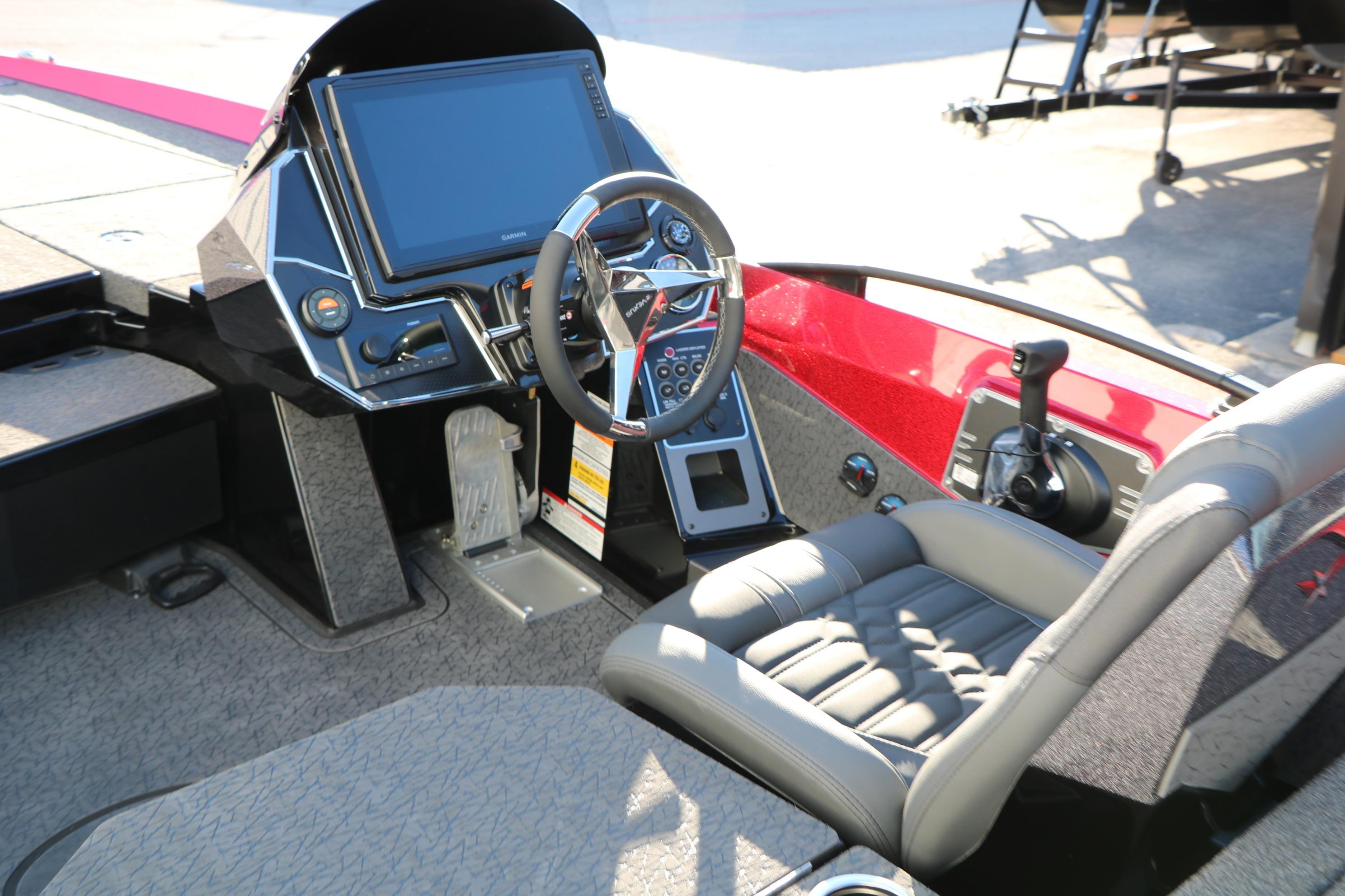 2026 Vexus VXs21 boat cockpit with steering wheel, control panel, and comfortable seating.