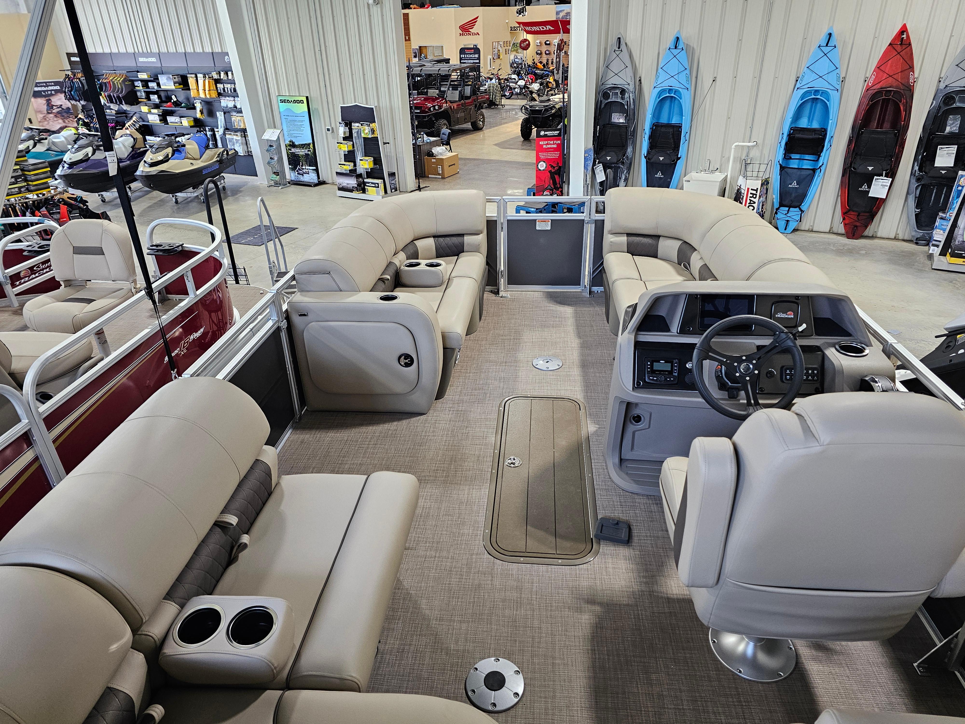 2024 Sun Tracker Party Barge 22 RF XP3 interior with plush seating and modern dashboard.