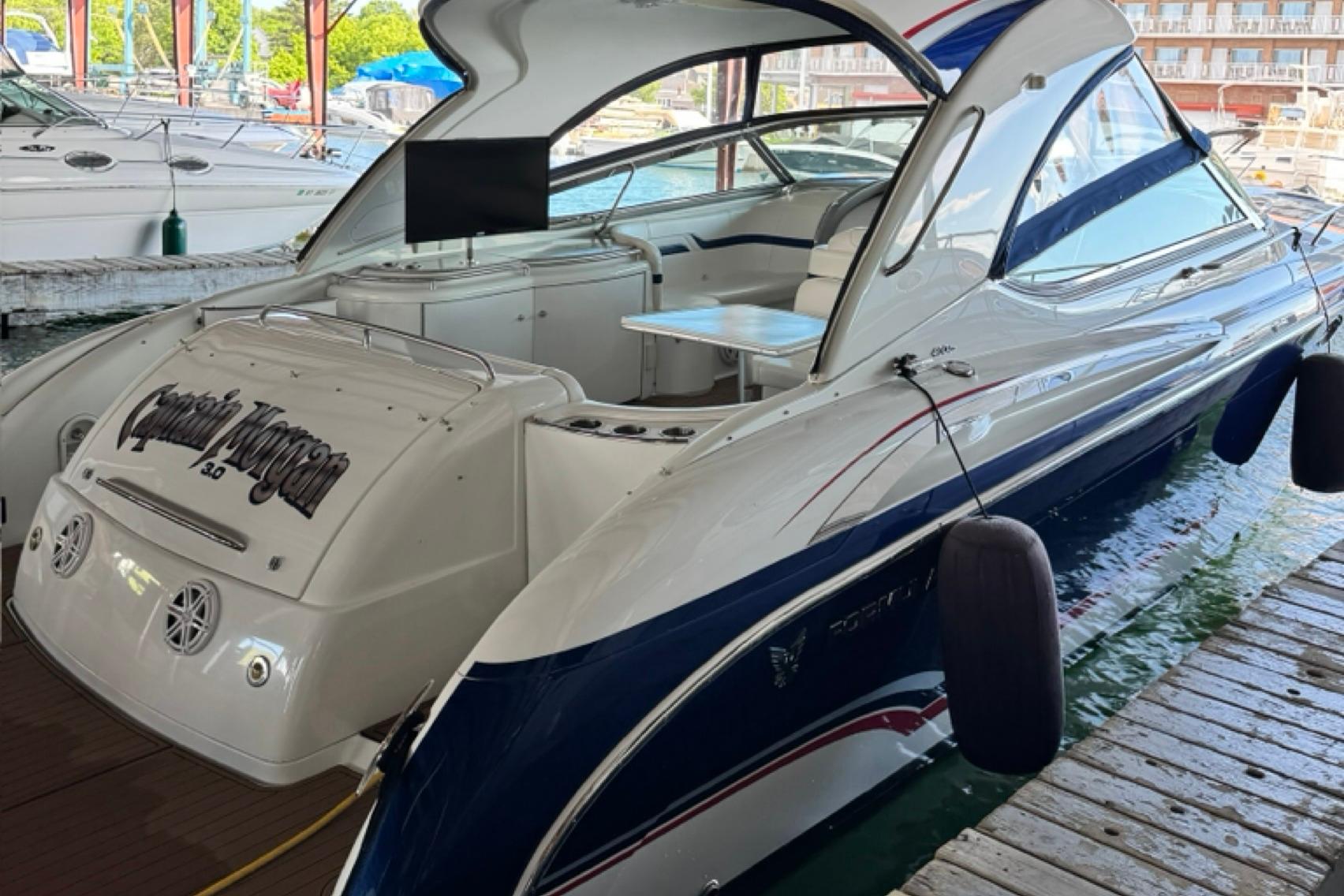 2008 Formula 400 Super Sport boat docked, featuring sleek design and spacious interior.