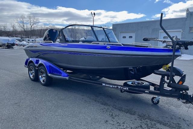 2026 Ranger 1880MS boat on trailer, blue and black design, parked outdoors.