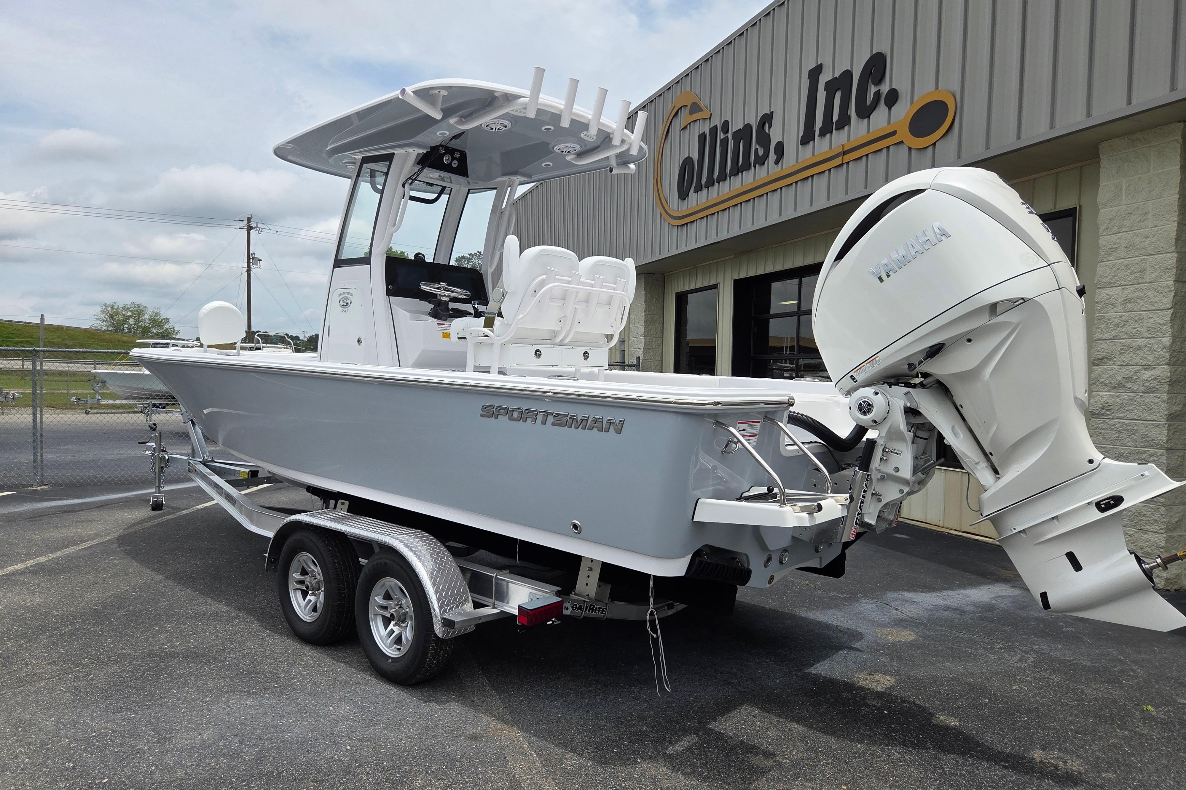 2026 Sportsman Masters 247 Bay Boat with Yamaha engine on trailer outside dealership.