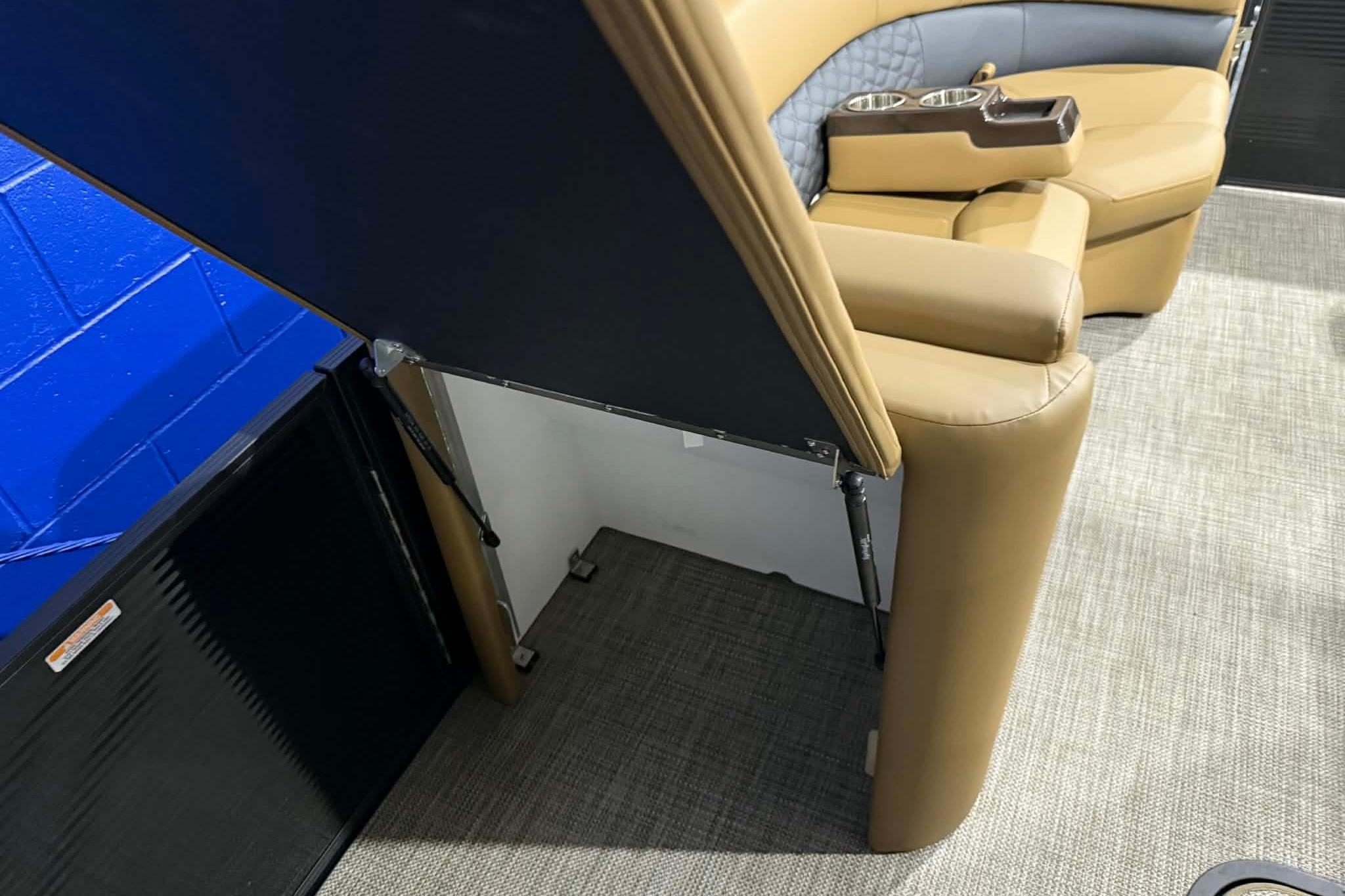 2026 Manitou Encore VP 230 interior with tan seating and cup holders.
