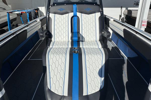2024 Fountain 34 SC boat interior with white and blue seating, modern design.