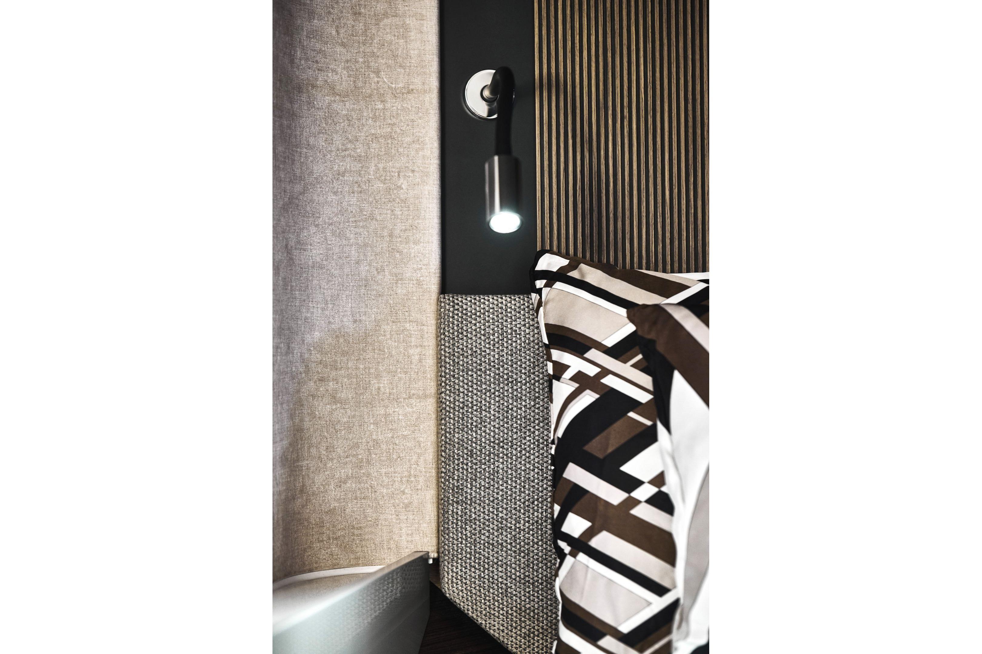 Modern interior design in Prestige X60, 2026 model, featuring stylish lighting and patterned bedding.