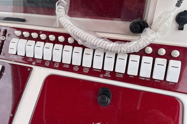 Control panel of a 2001 Fountain 38 Center Console boat with labeled switches.