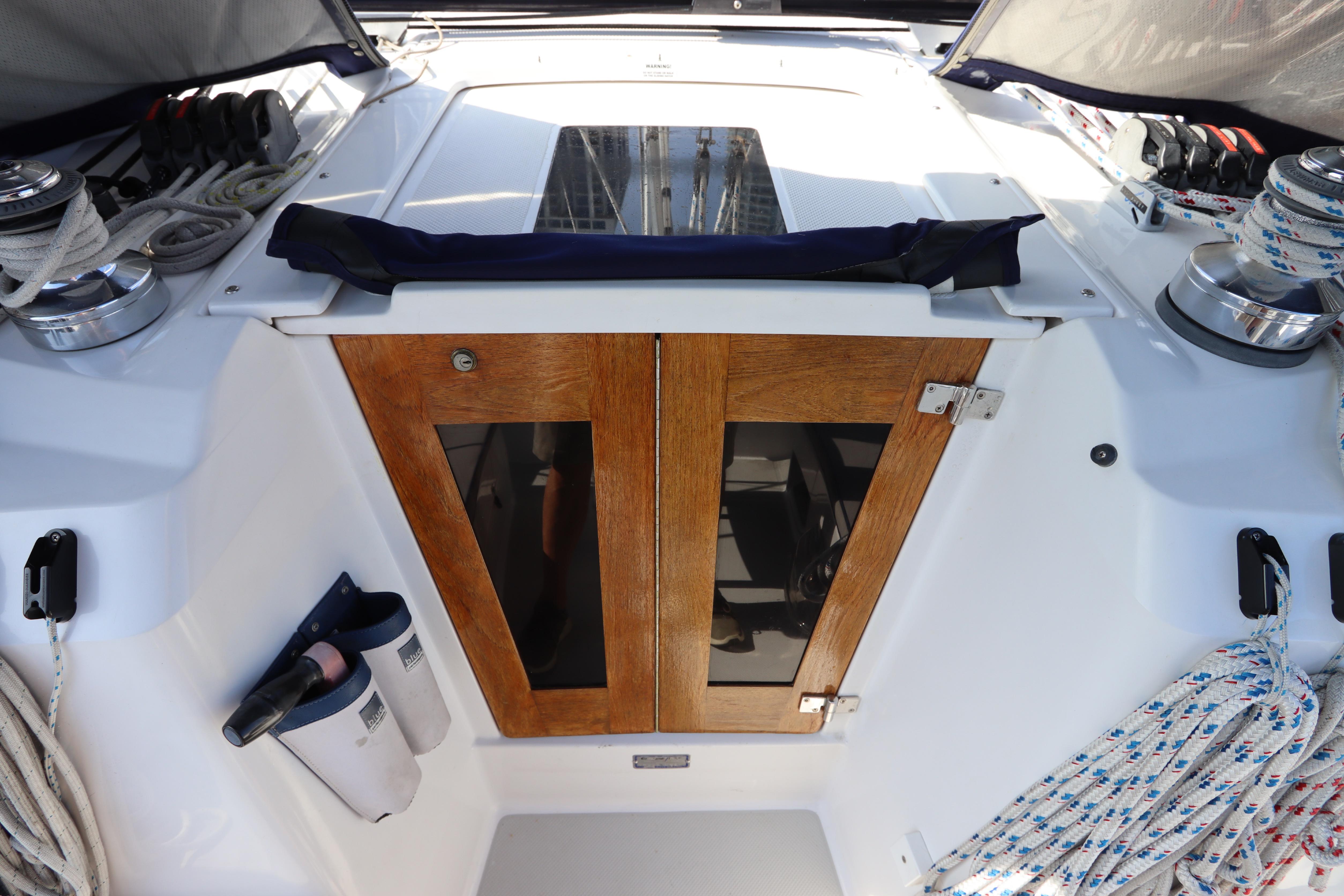 Cockpit of 2011 Catalina 355 sailboat with wooden doors and winches.
