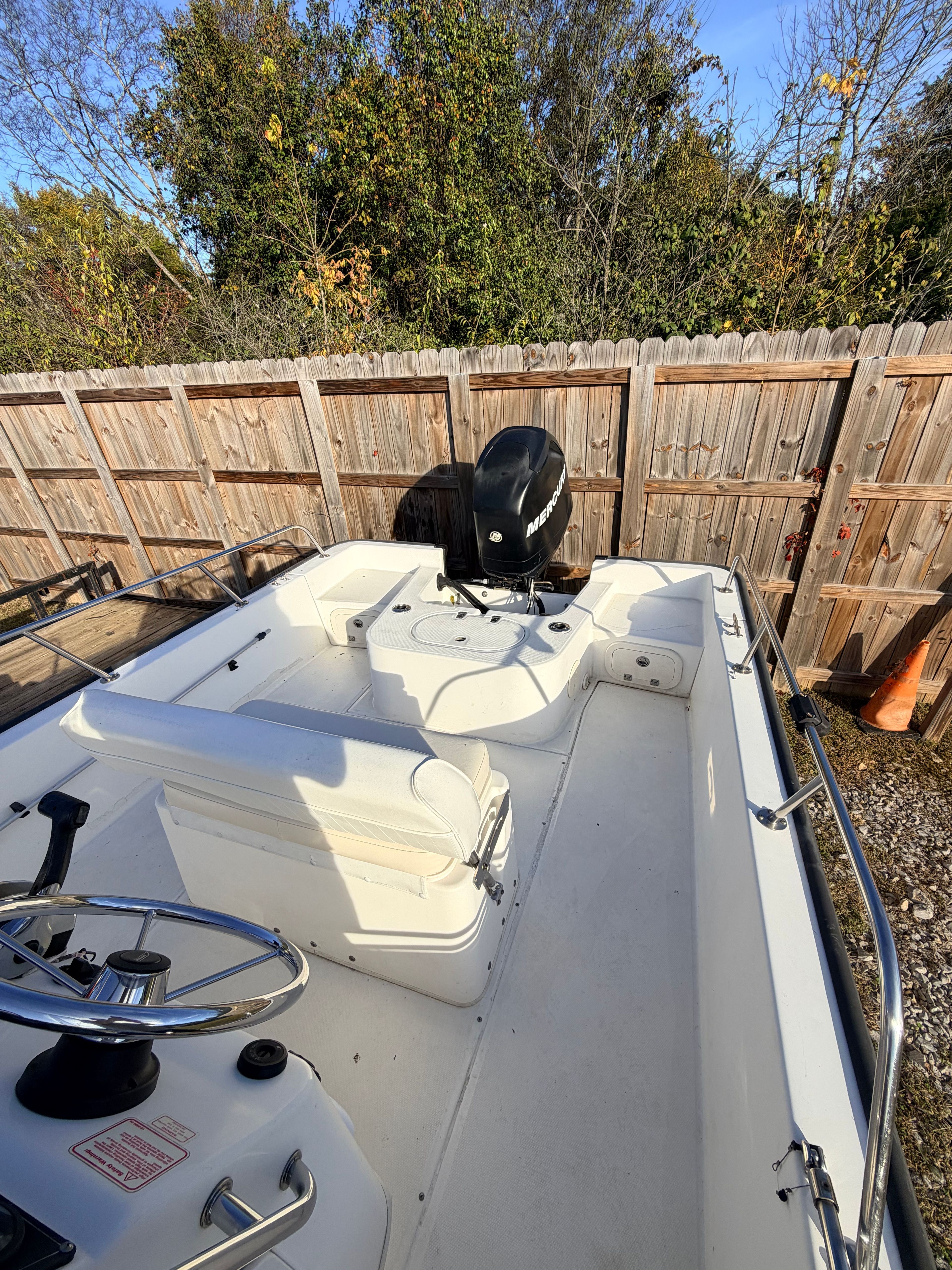 A 2007 Boston Whaler 190 Montauk on dry land. It features an open cockpit and outboard motor.