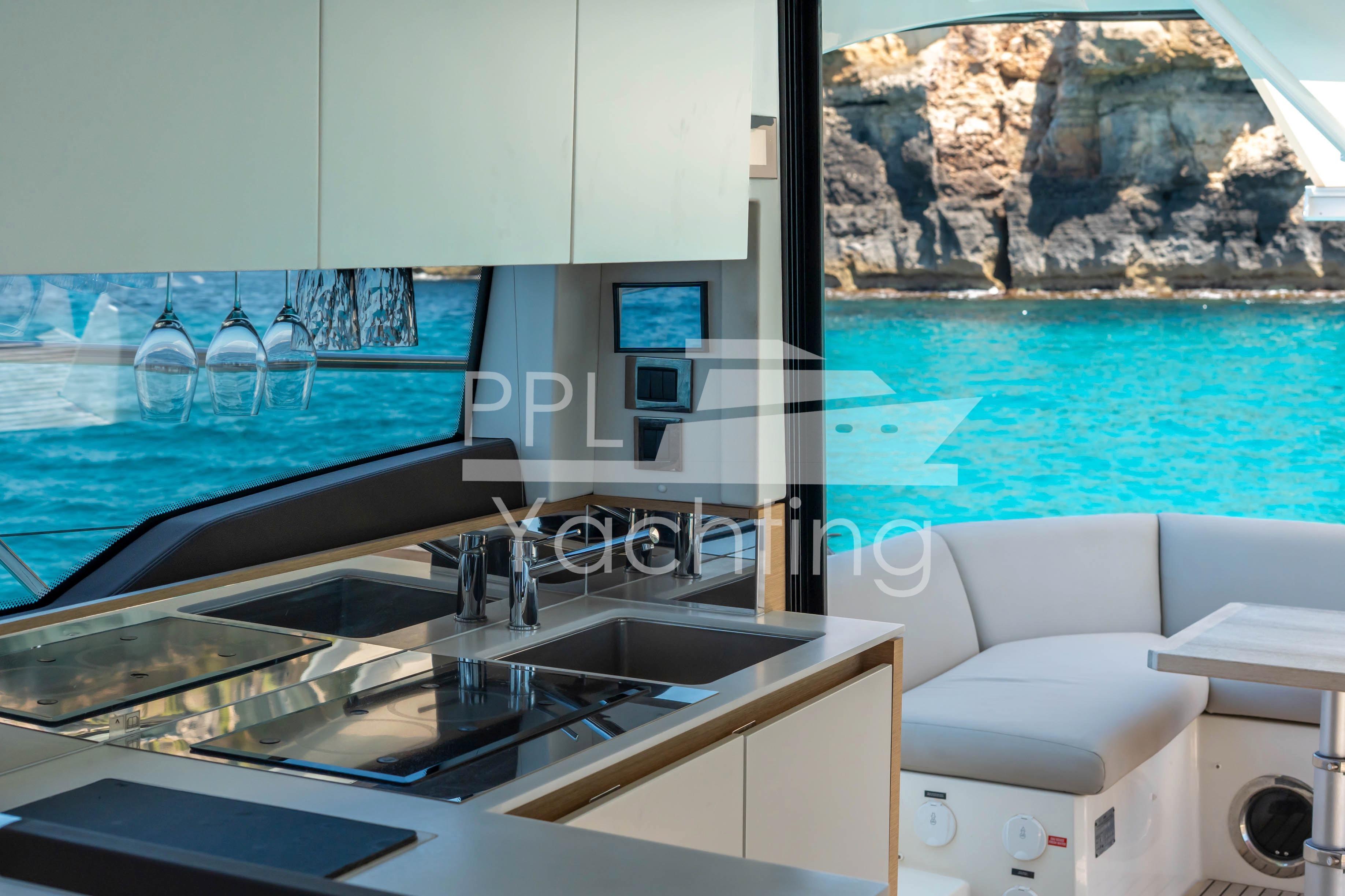 Luxurious 2019 Prestige 460 yacht interior with ocean view and modern kitchen amenities.
