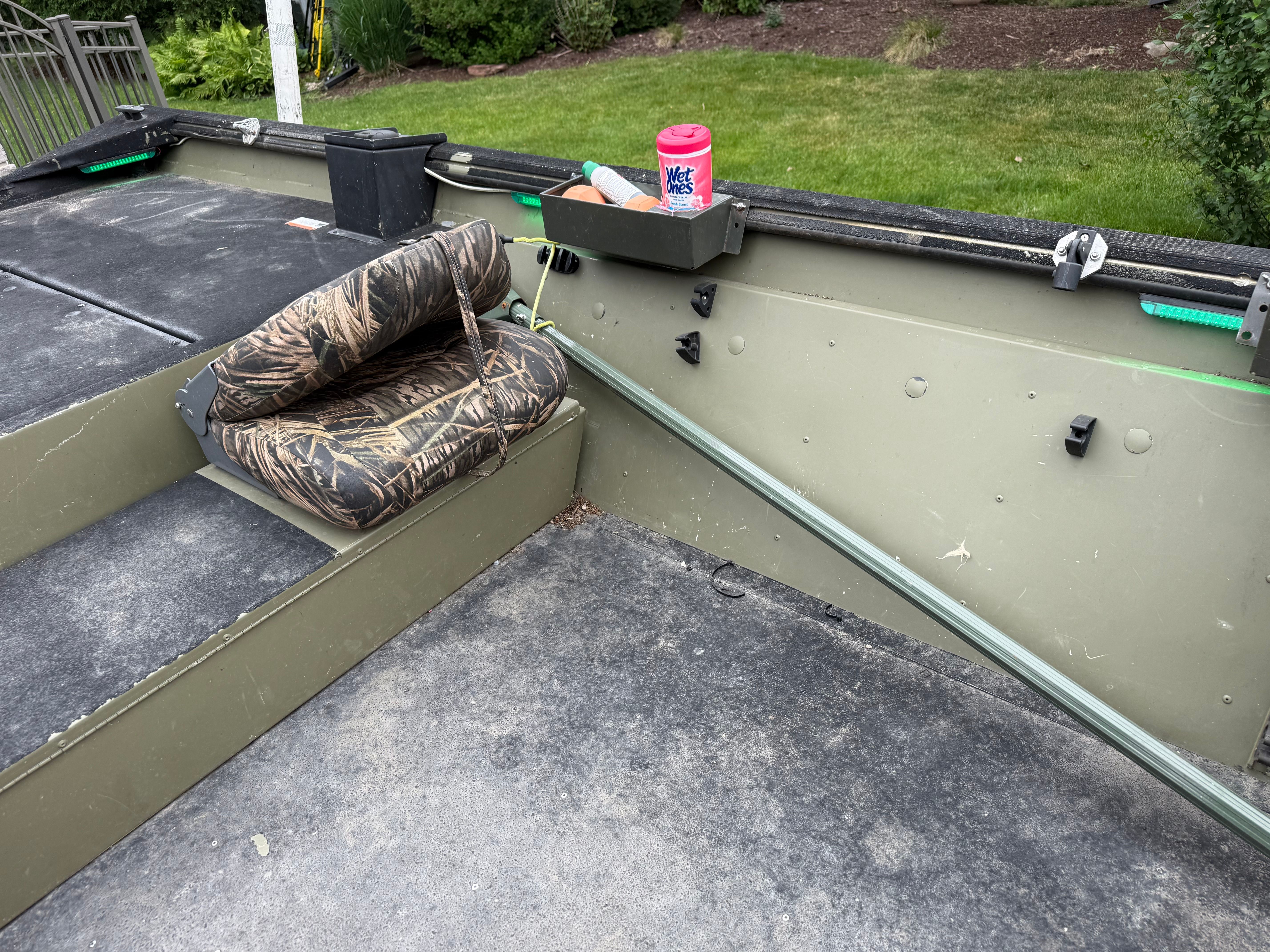 The image shows the interior of a 2013 Lowe RX2070SC boat. It features camo upholstery and an open deck area.