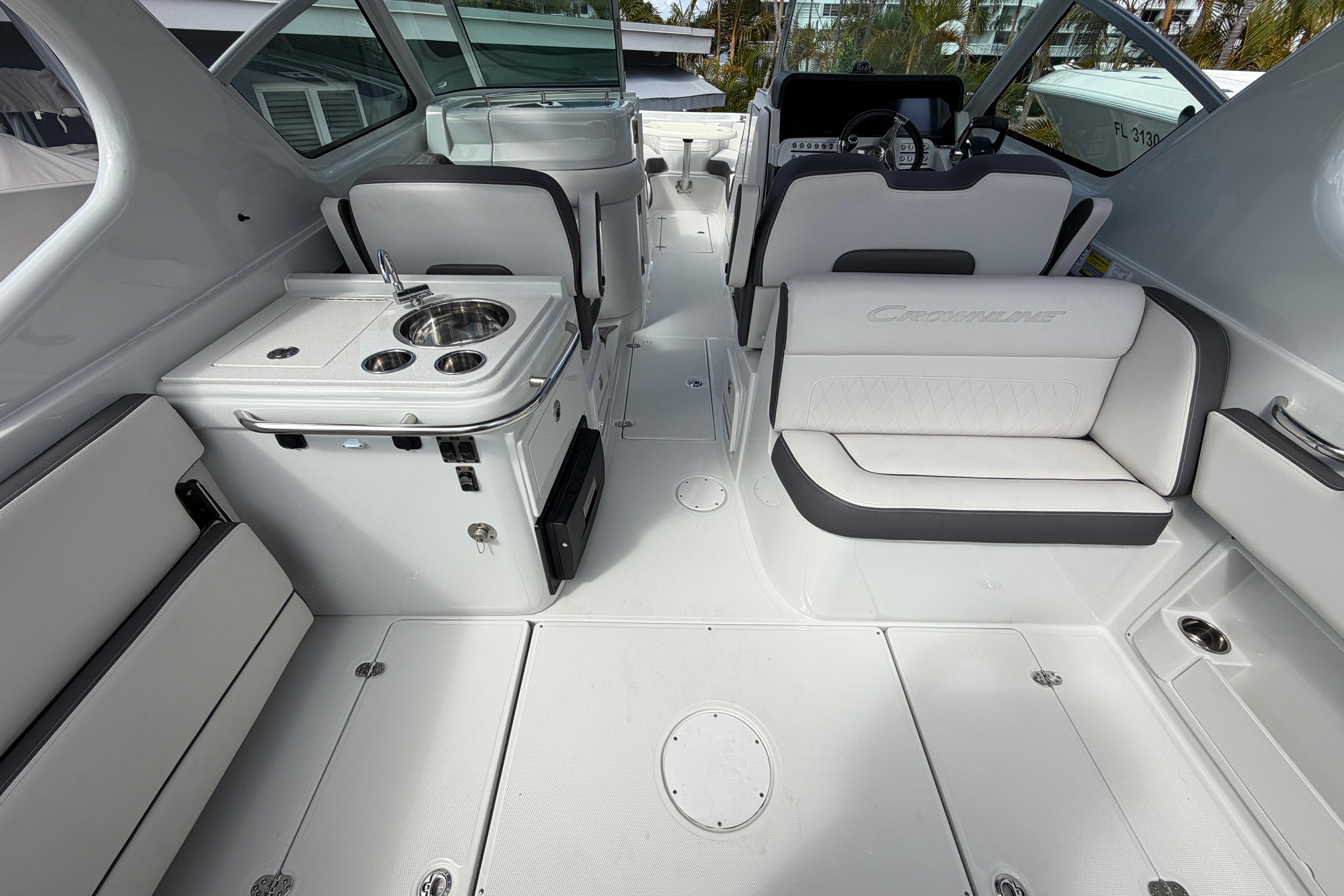 2024 Crownline 260 DC Finseeker boat interior with seating and kitchenette.