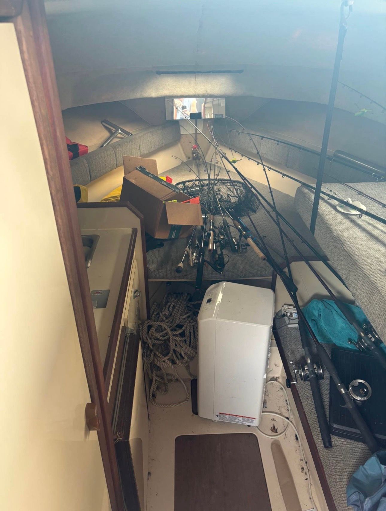 Interior of a boat with fishing gear and ropes.