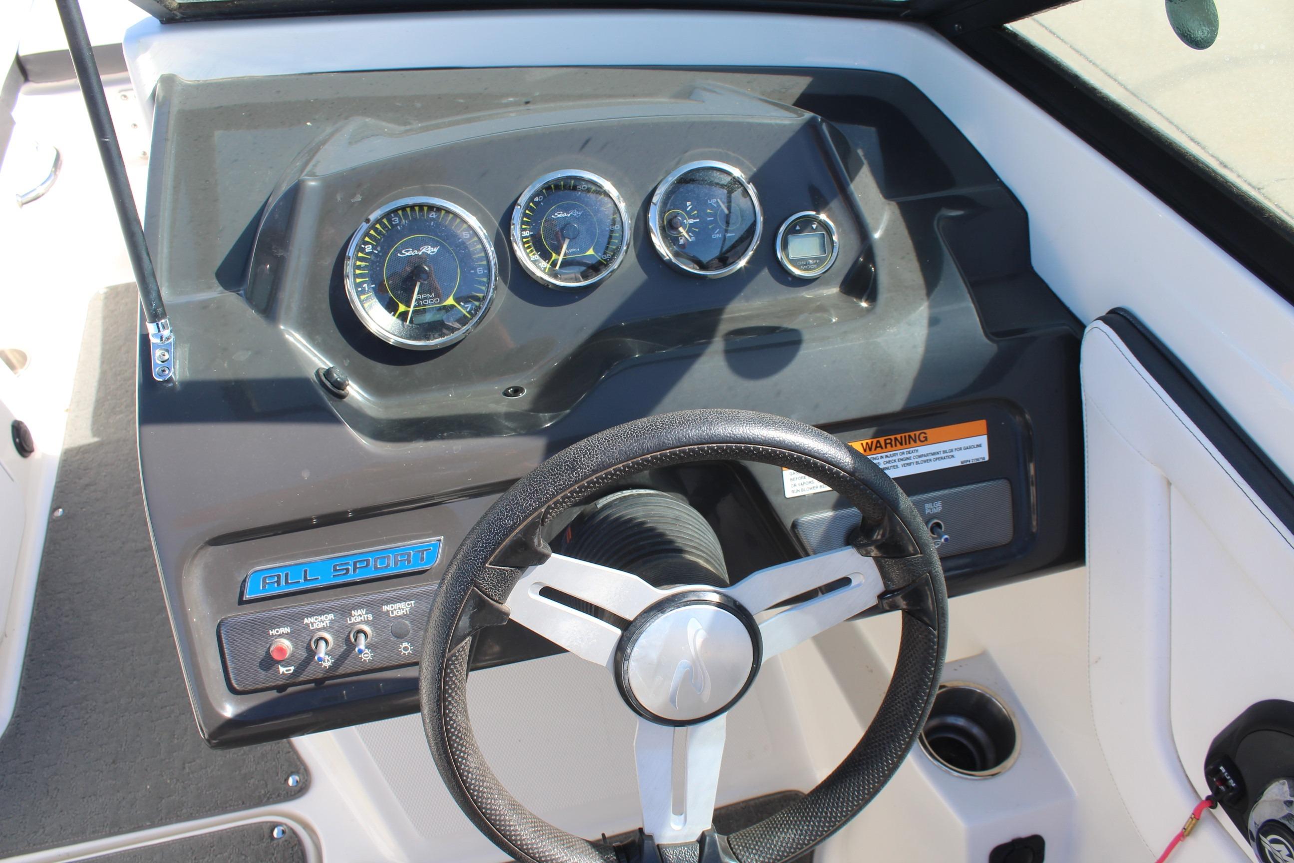 Dashboard of a 2015 Sea Ray 19 SPX OB boat with steering wheel and gauges.