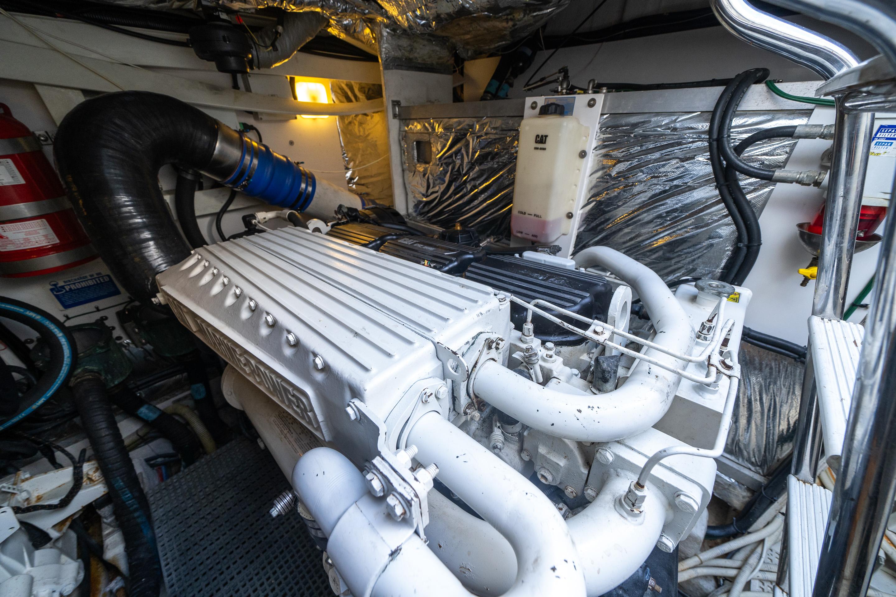 Engine room of 2012 Princess V52 yacht, featuring a well-maintained marine engine.