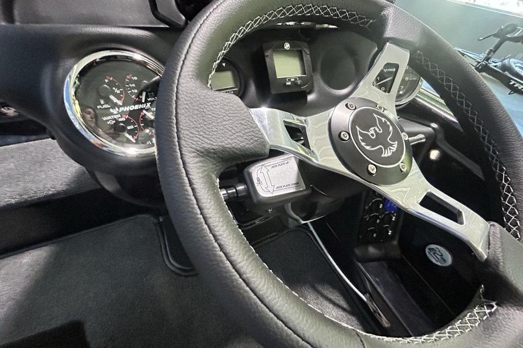 Steering wheel and dashboard of 2026 Phoenix 819 ZXL with gauges and logo.