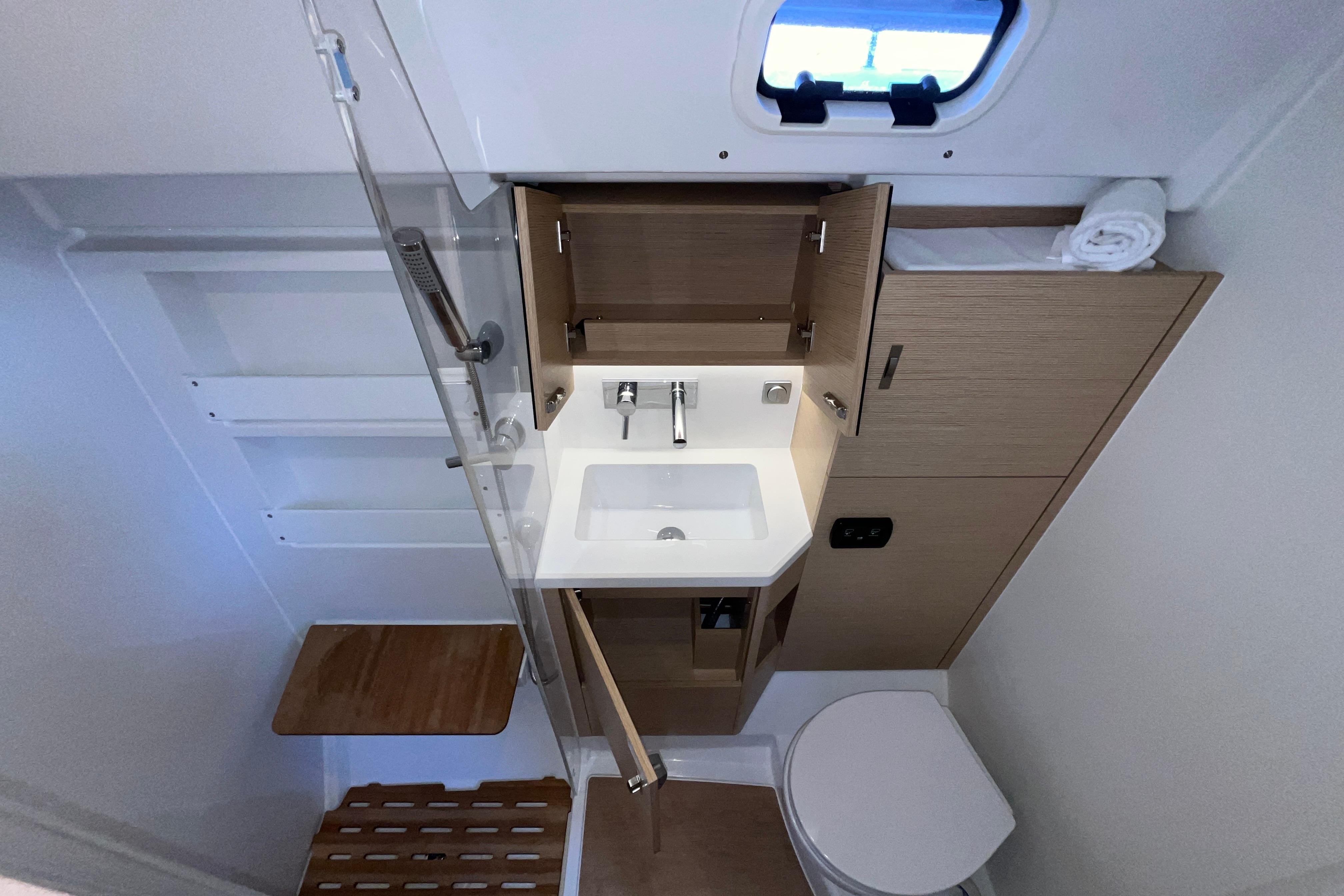 Modern bathroom interior of 2025 Hanse 360 yacht, featuring sink, toilet, and wooden accents.