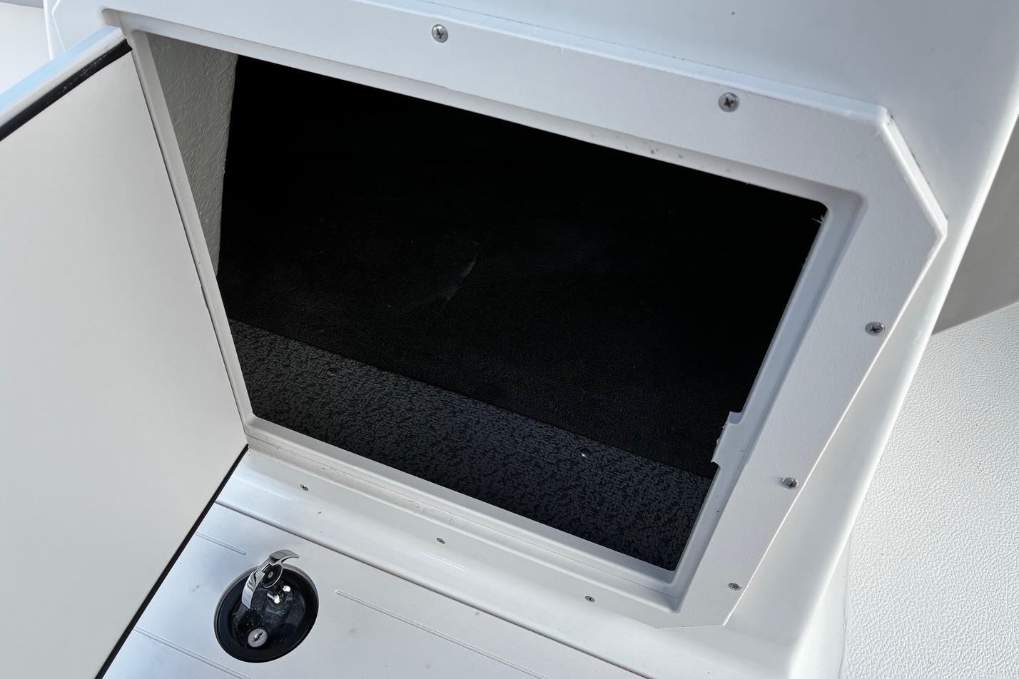 Storage compartment on 2026 Starcraft SVX 191 OB boat, featuring a sleek white interior.