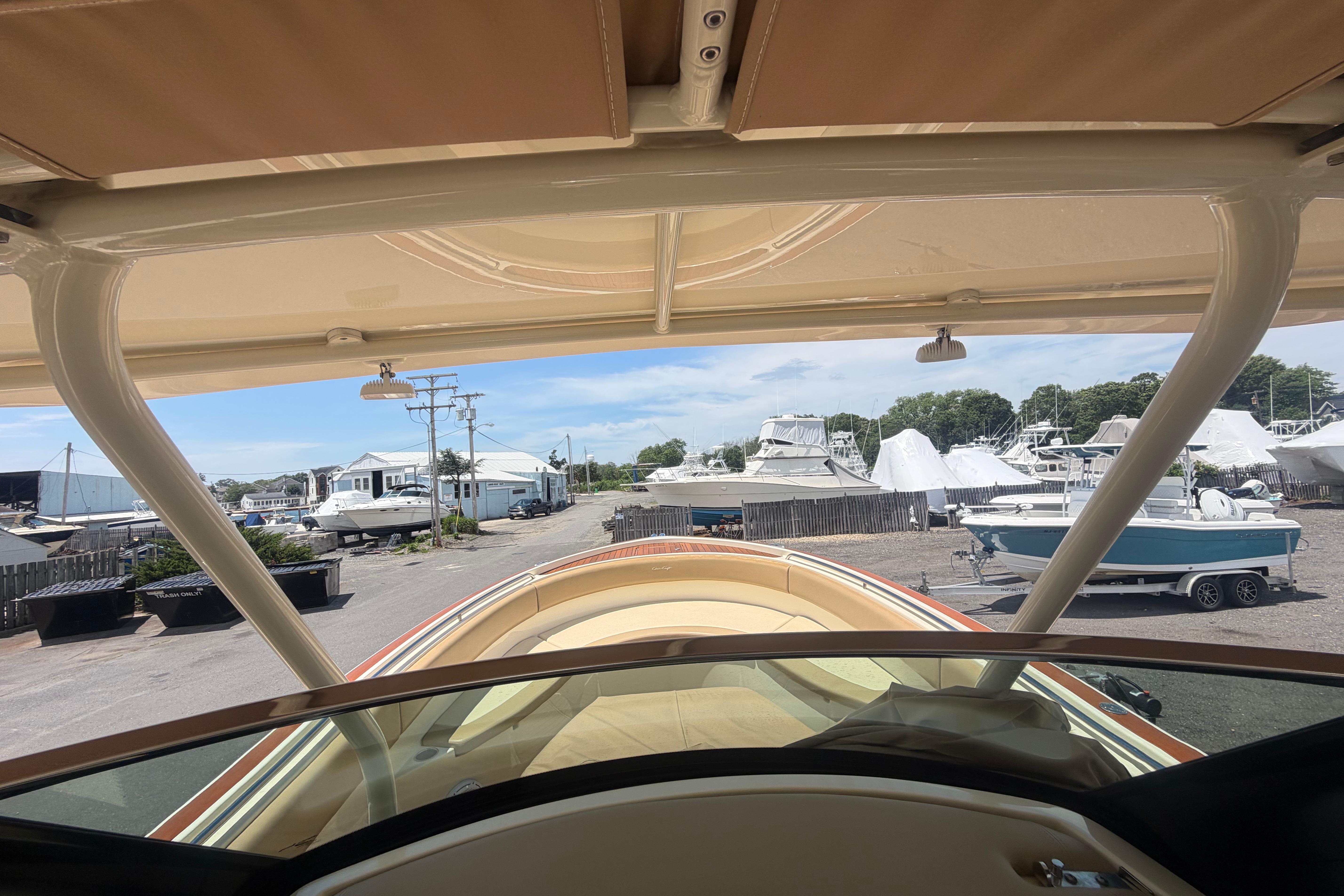 2017 Chris-Craft Catalina 34 boat view from helm, marina background, clear sky.