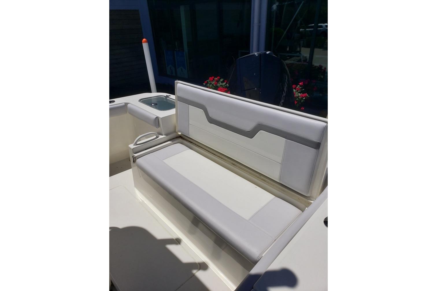 2026 Mako 226 Center Console boat with cushioned seating and sleek design.